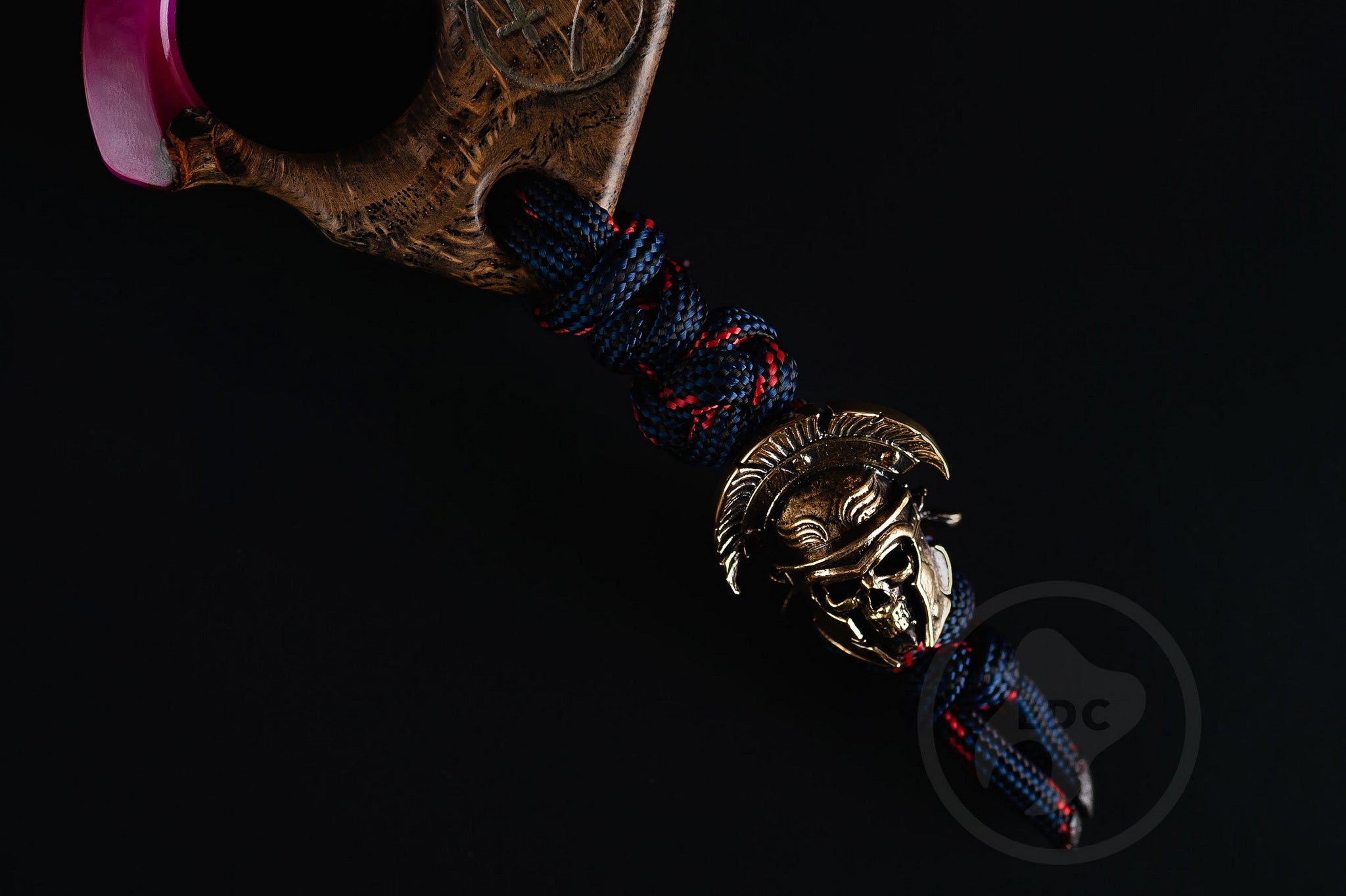 Close up of solid brass Roman Centurion helmet bead on purple lanyard, Texture detail of purple resin and oak wood pocket art-5