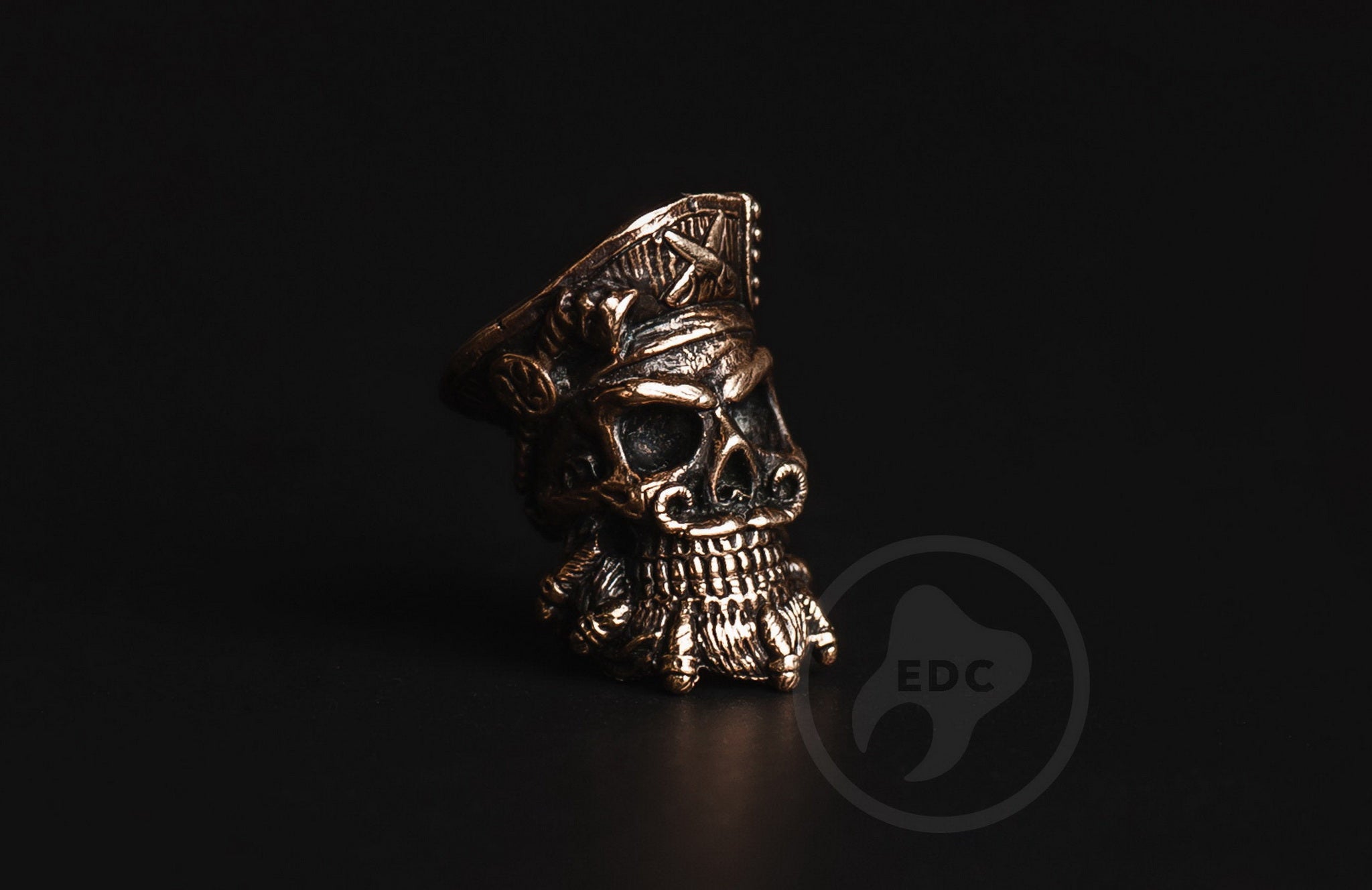 Close-up of the detailed beard and skull features on the brass pirate EDC bead.-2