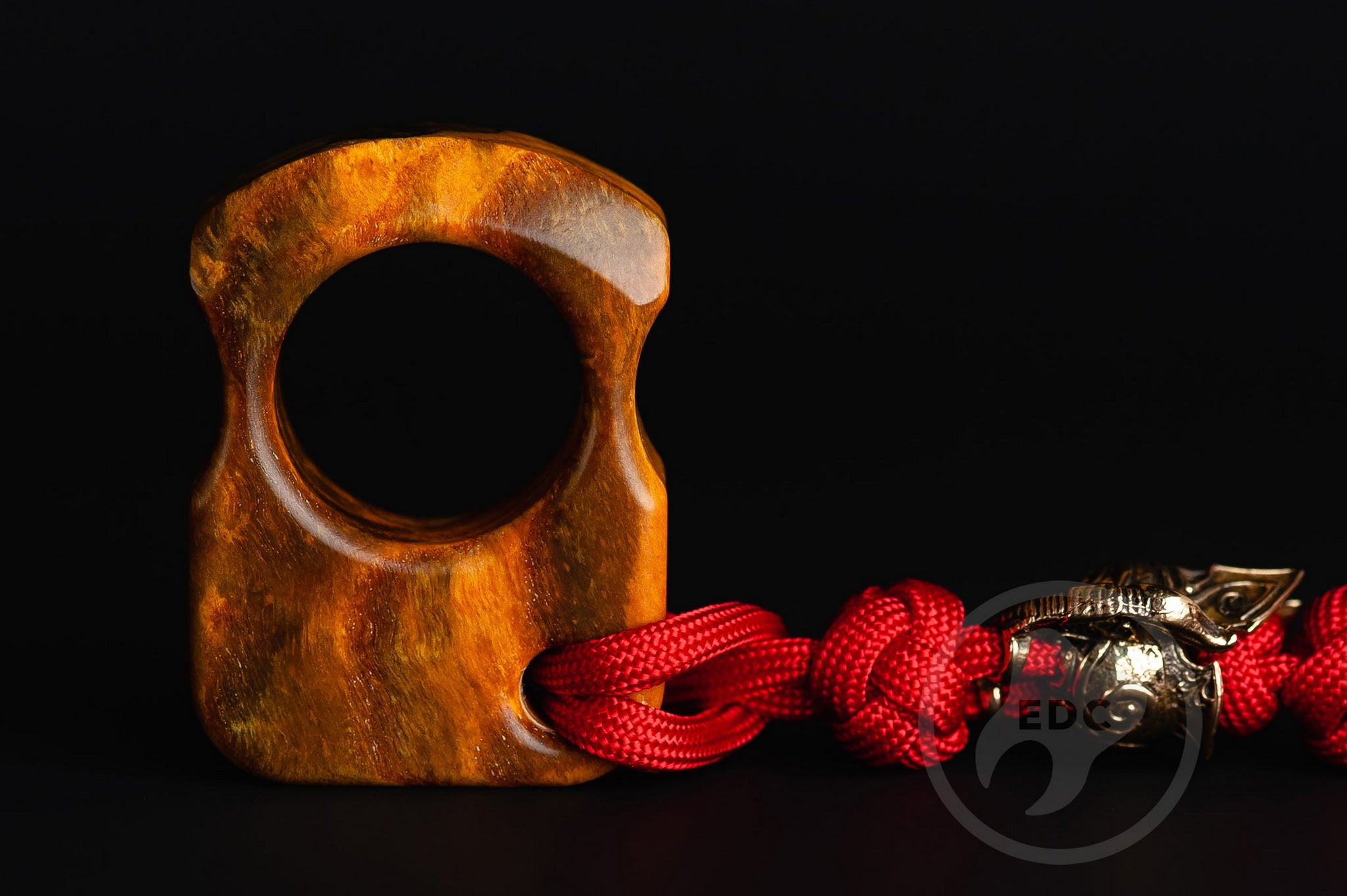 Close up of solid brass Spartan helmet bead on lanyard, Texture detail of curly ash burl pocket sculpture-2