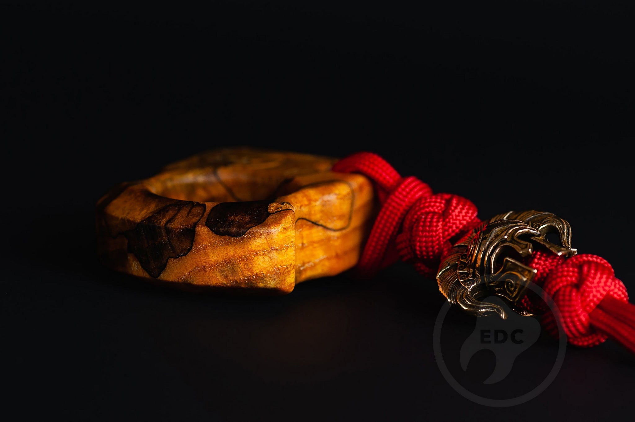Close up of solid brass Spartan helmet bead on lanyard, Texture detail of curly ash burl pocket sculpture-4