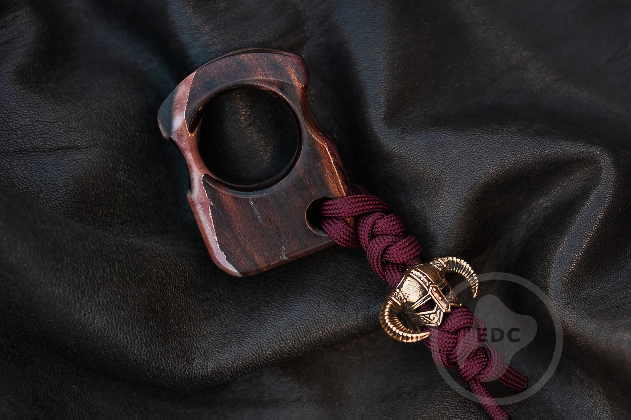 Close up of brass Dragonborn warrior bead on hybrid wood EDC tool, Texture detail of marble and snow resin effect on stabilized wood-3