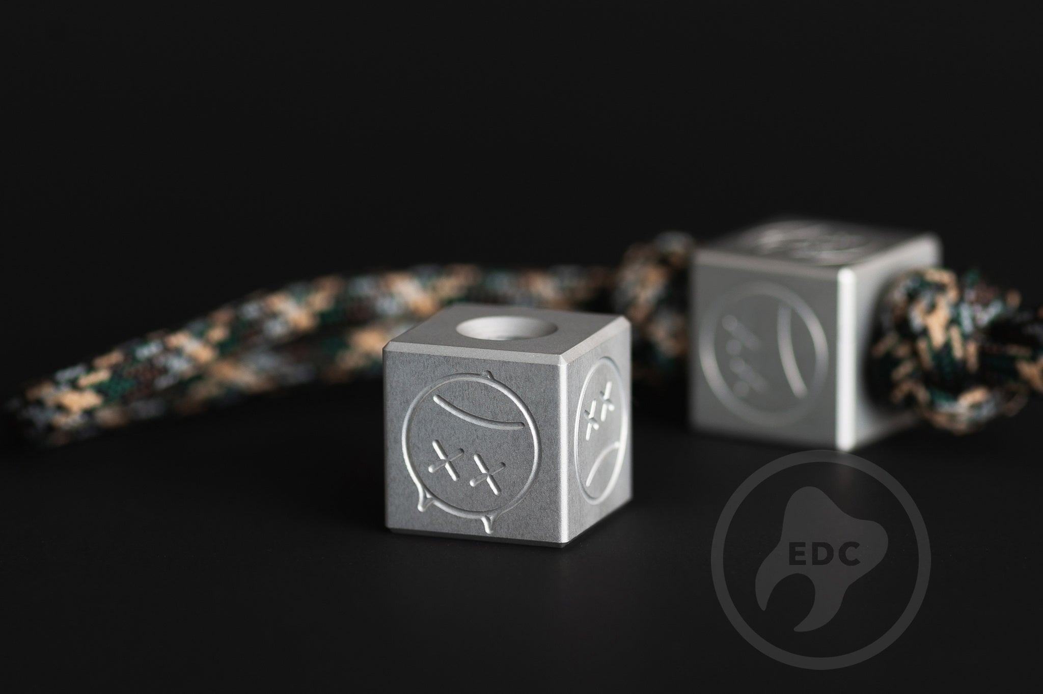 Grey aluminum Sad Face bead showing the top profile and 6mm hole.-1