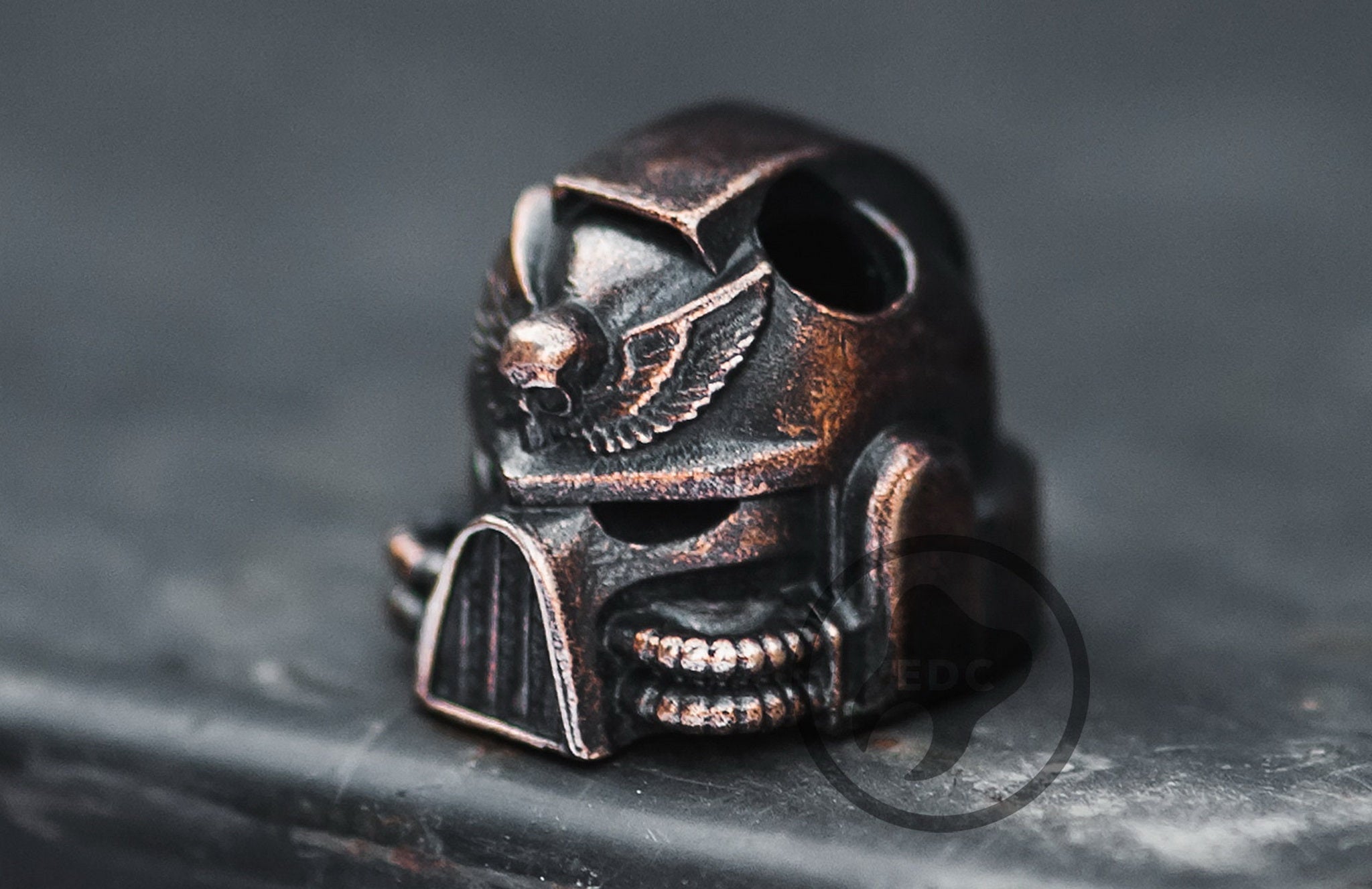 Close-up of the blackened and polished finish on the brass Warhammer 40k inspired helmet bead.