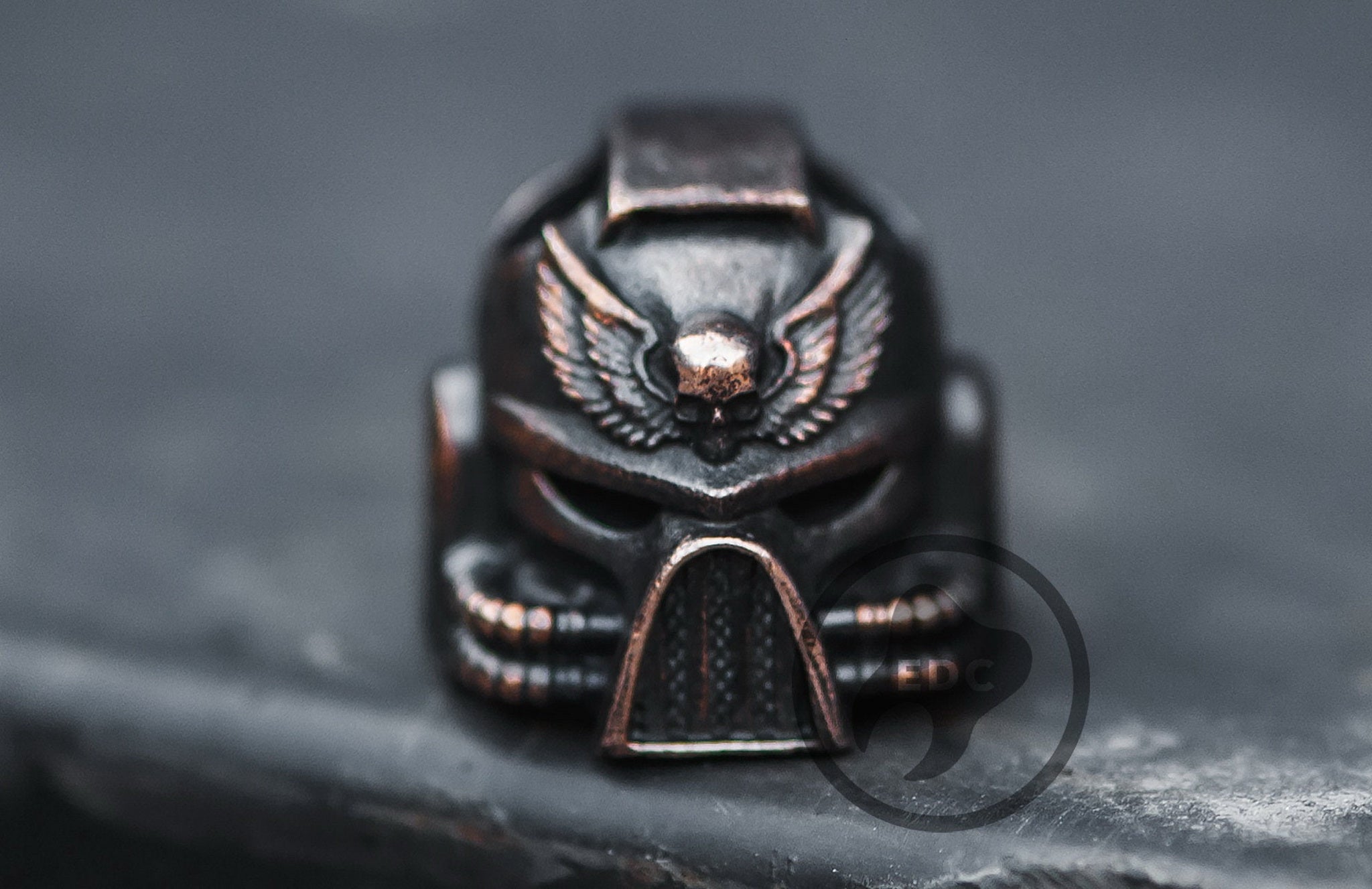 Close-up of the blackened and polished finish on the brass Warhammer 40k inspired helmet bead.-1