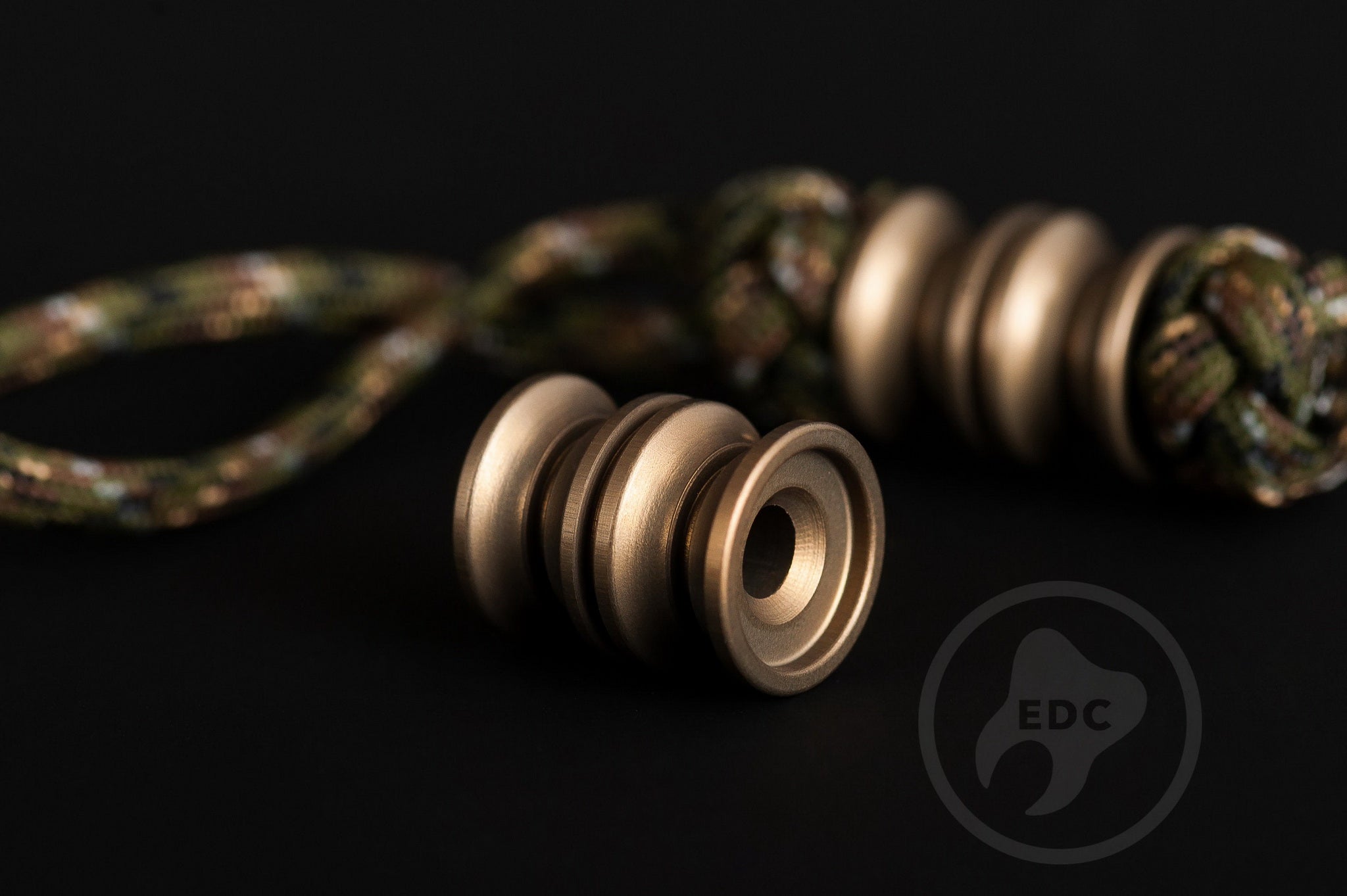 Hardcoat anodized aluminum Grooved Barrel lanyard bead with sandblasted finish.