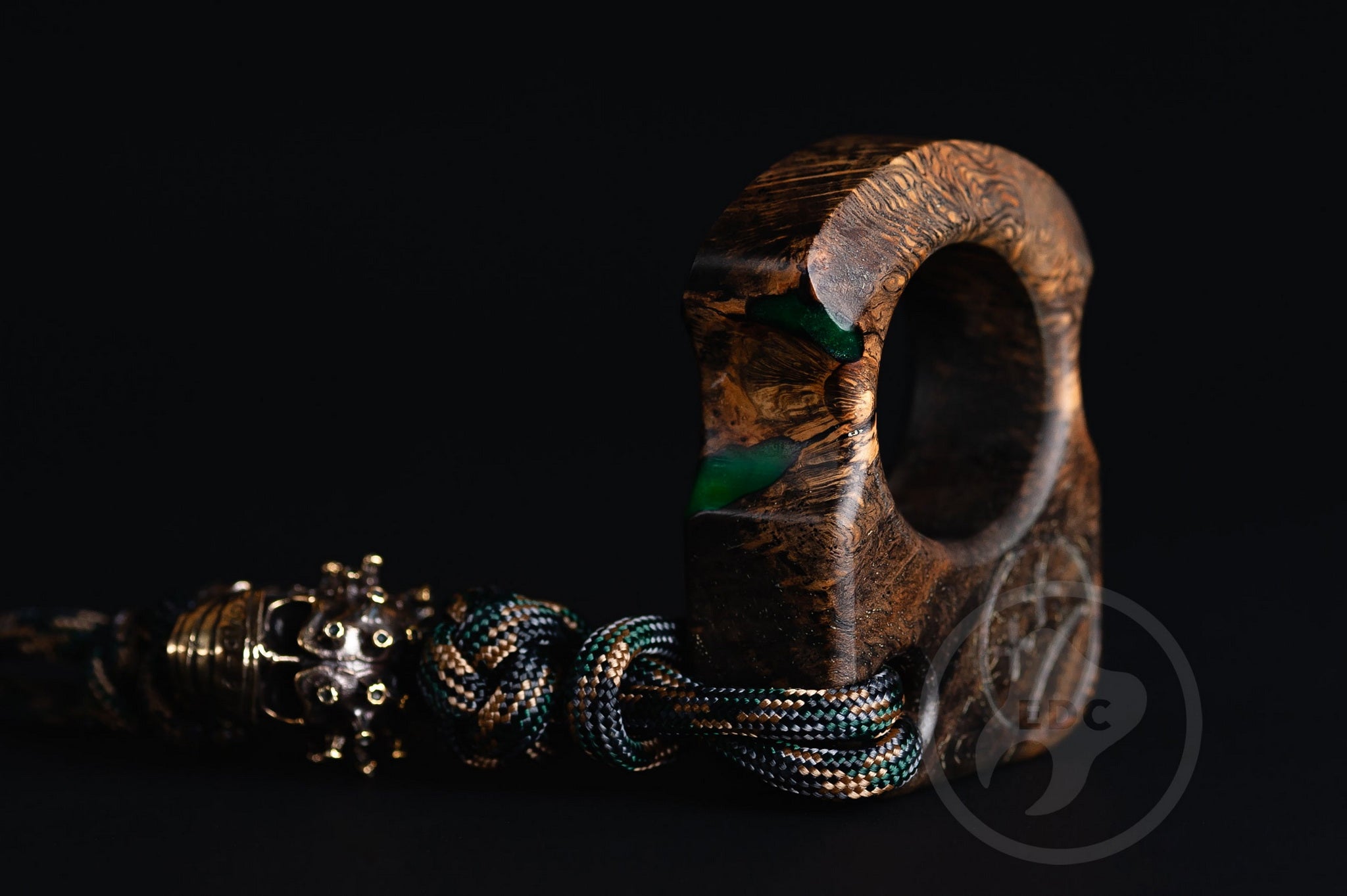 Close up of solid brass Covid-19 bead on green lanyard, Texture detail of oak burl and green resin pocket sculpture-1