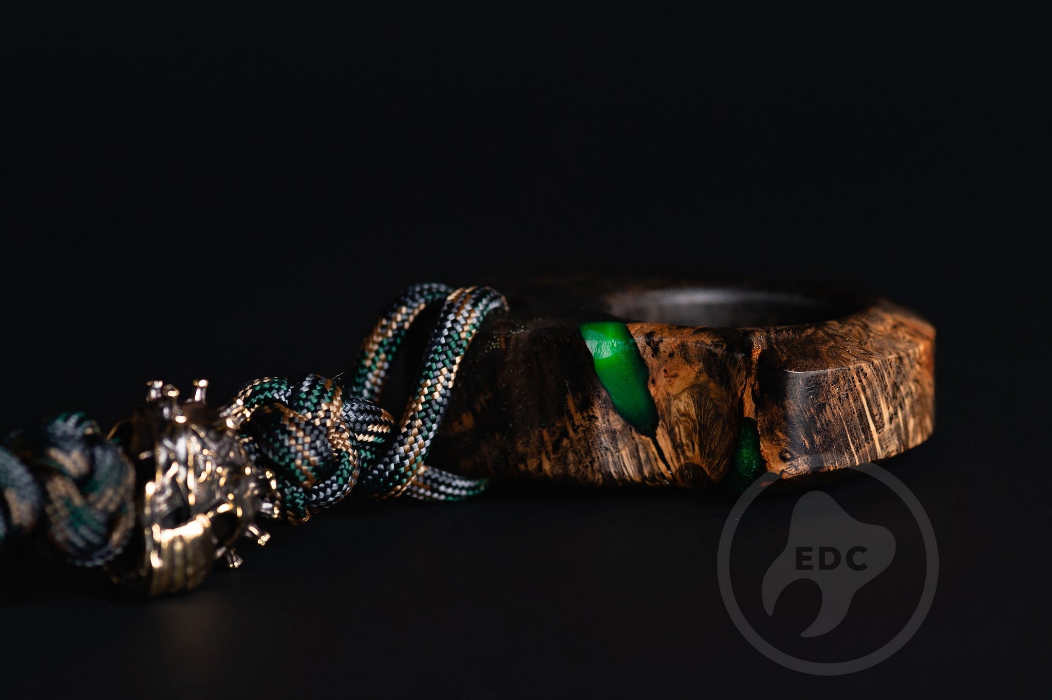 Close up of solid brass Covid-19 bead on green lanyard, Texture detail of oak burl and green resin pocket sculpture-3