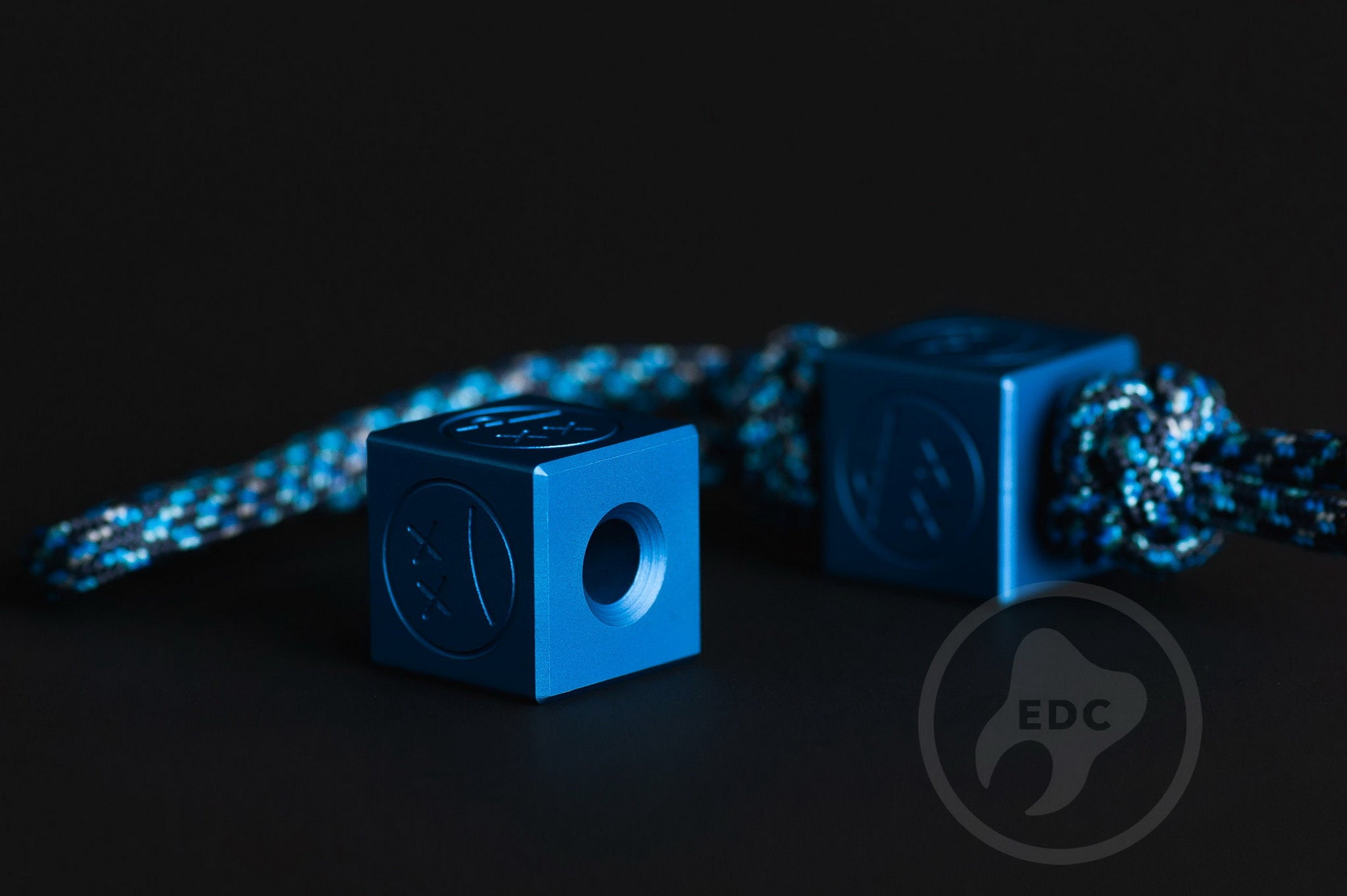 Matte blue aluminum bead showing the top and lanyard hole.