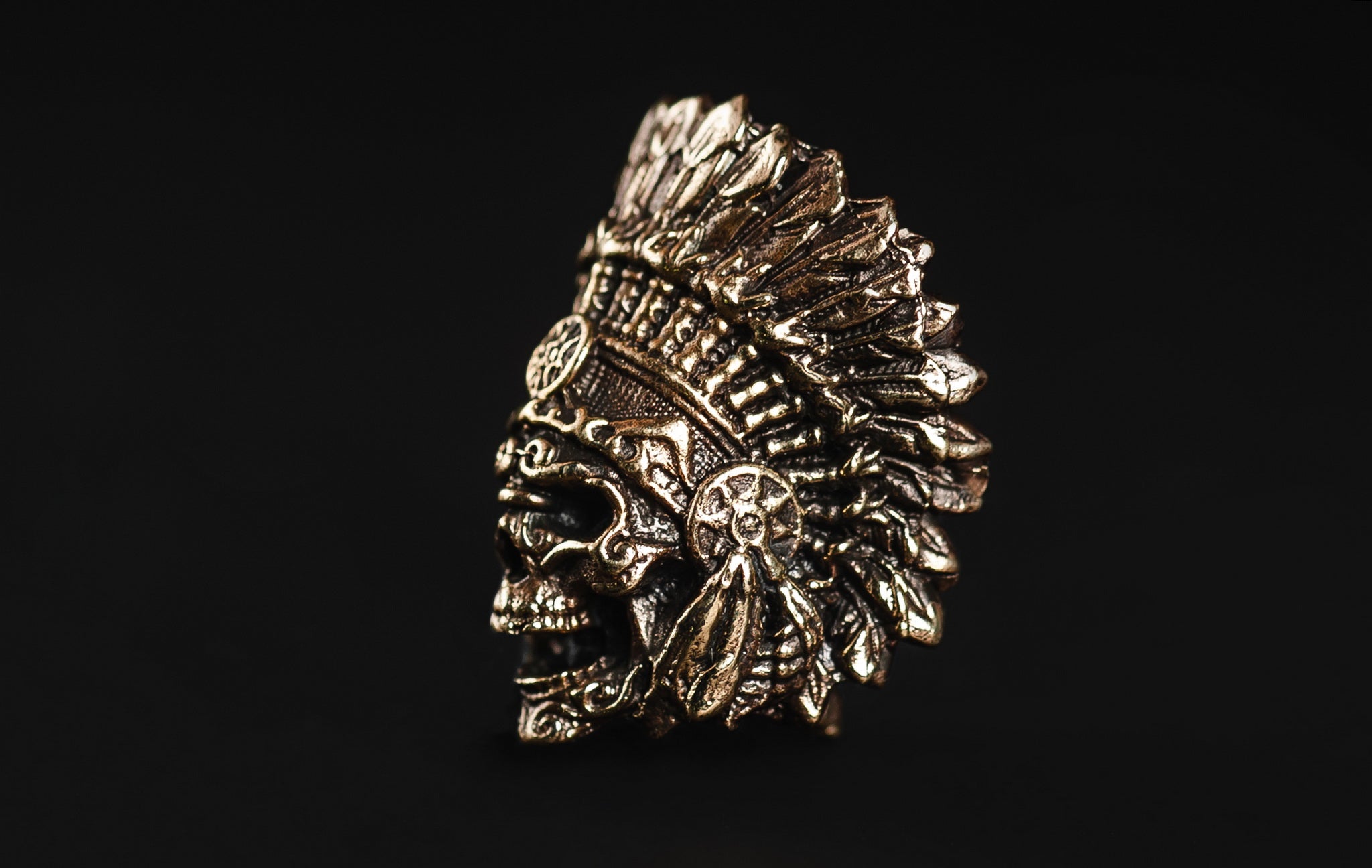 Detailed view of the eagle feather headdress on the brass Indian Chief bead.-1