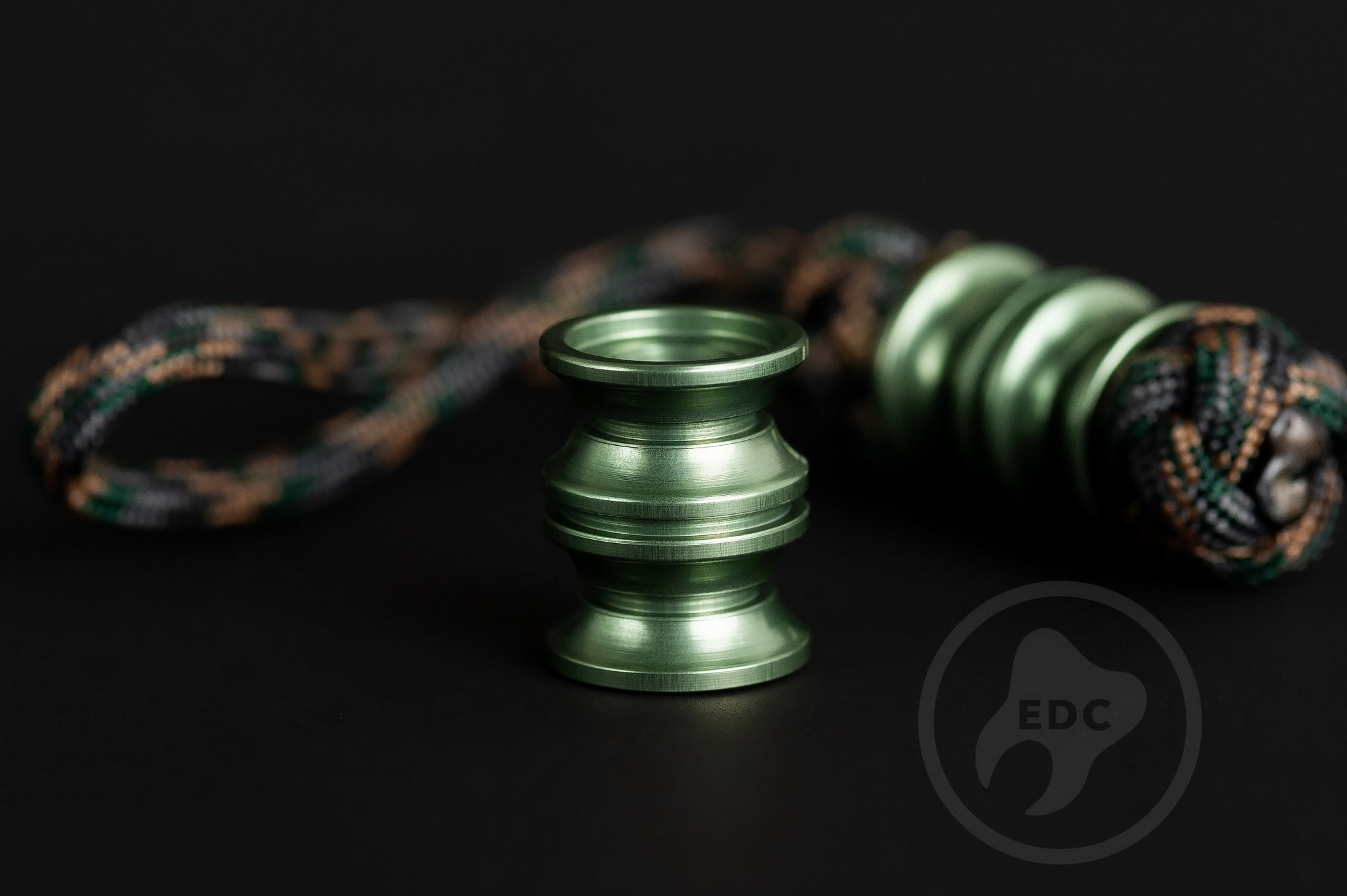 Durable olive green lanyard bead for outdoor gear and custom tool setups.