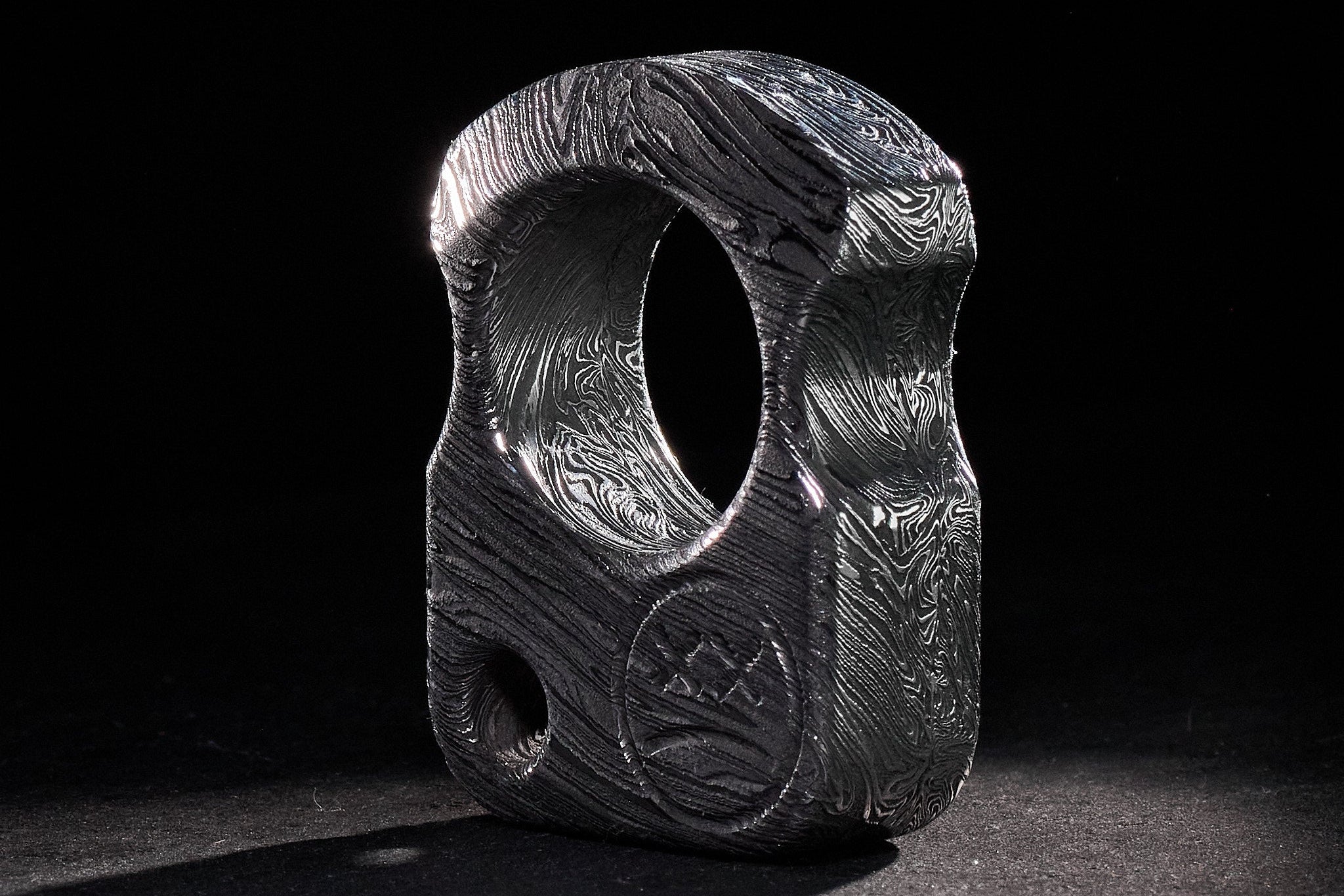 Base view of the S01 Damascus EDC accessory with lanyard hole detail.