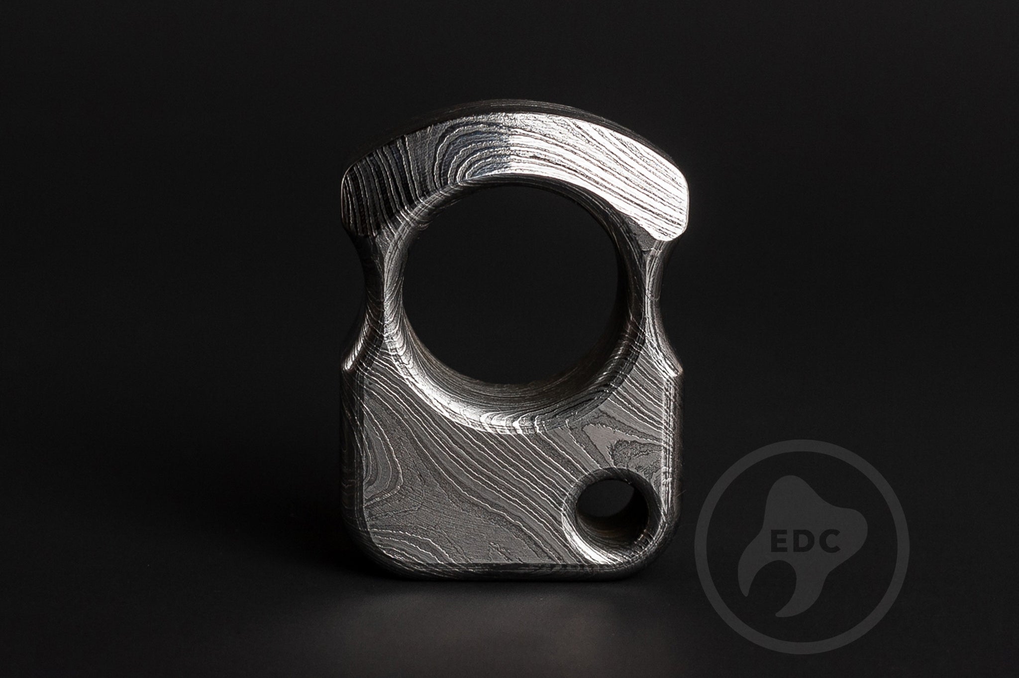 Detailed view of hand-polished and acid-etched Damascus steel texture