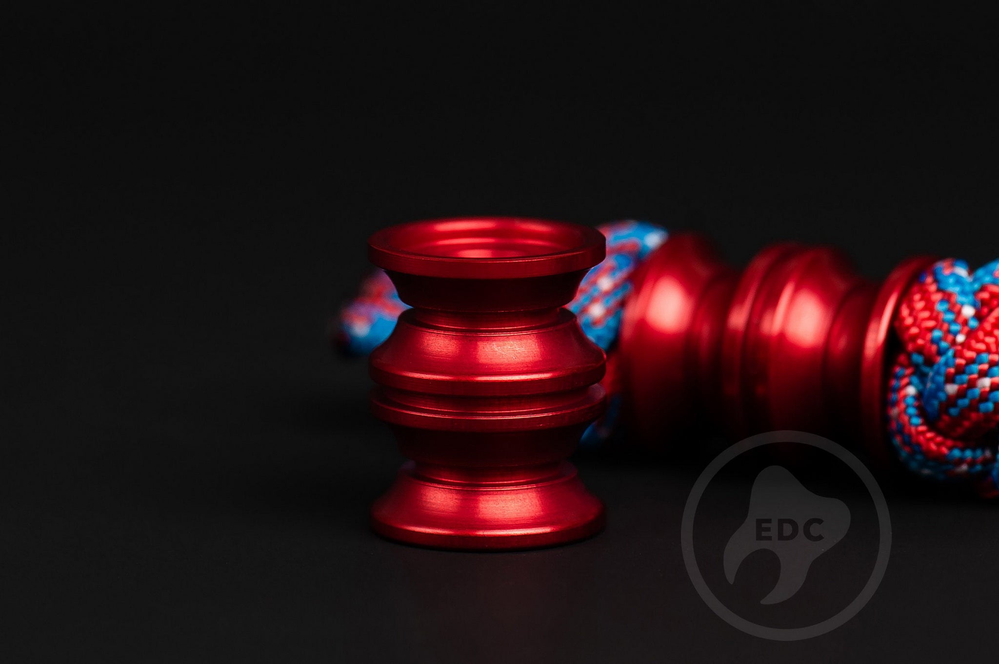 Vibrant red metal lanyard bead for custom gear and keychain setups.