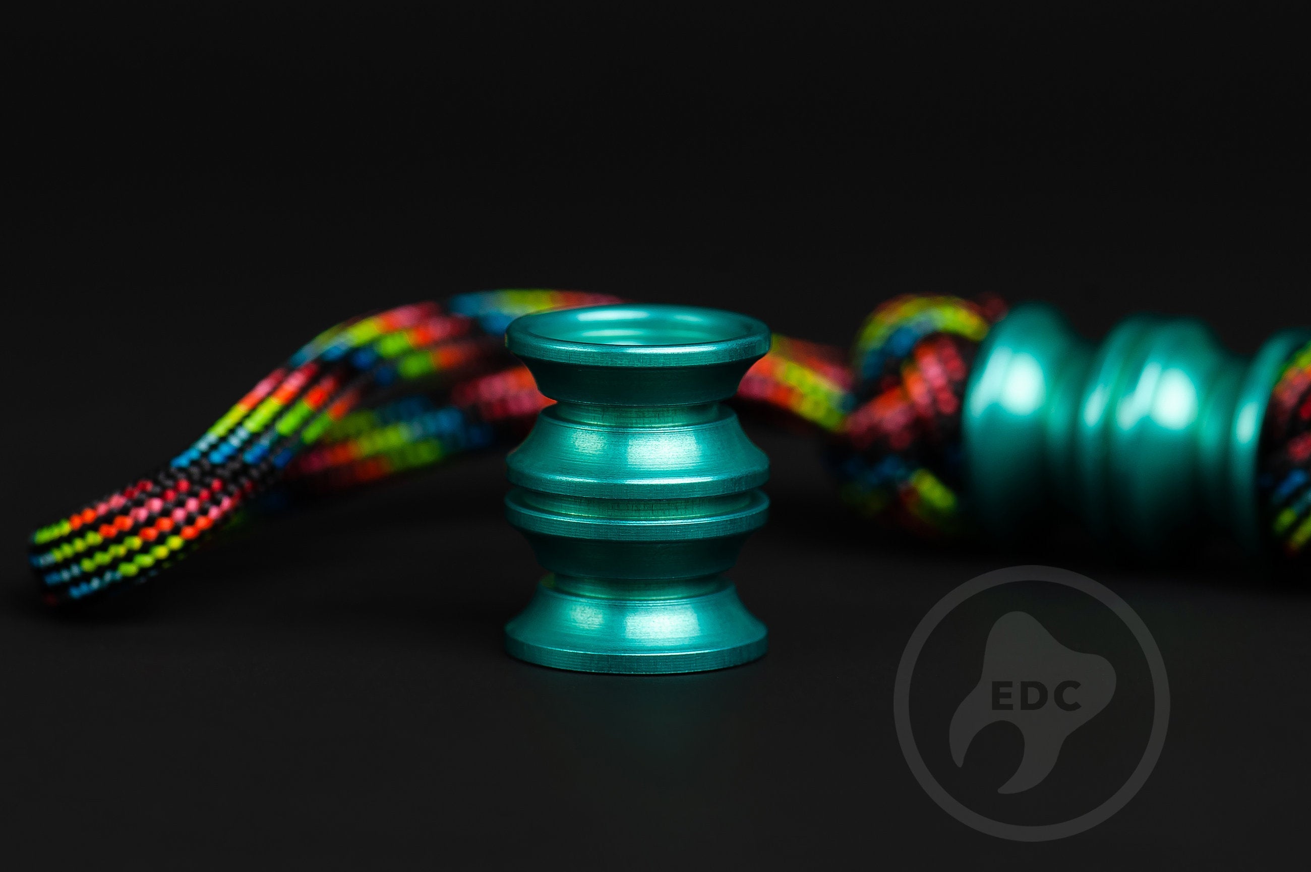 Teal Grooved Barrel bead showing the 6mm hole for 550 paracord attachment.