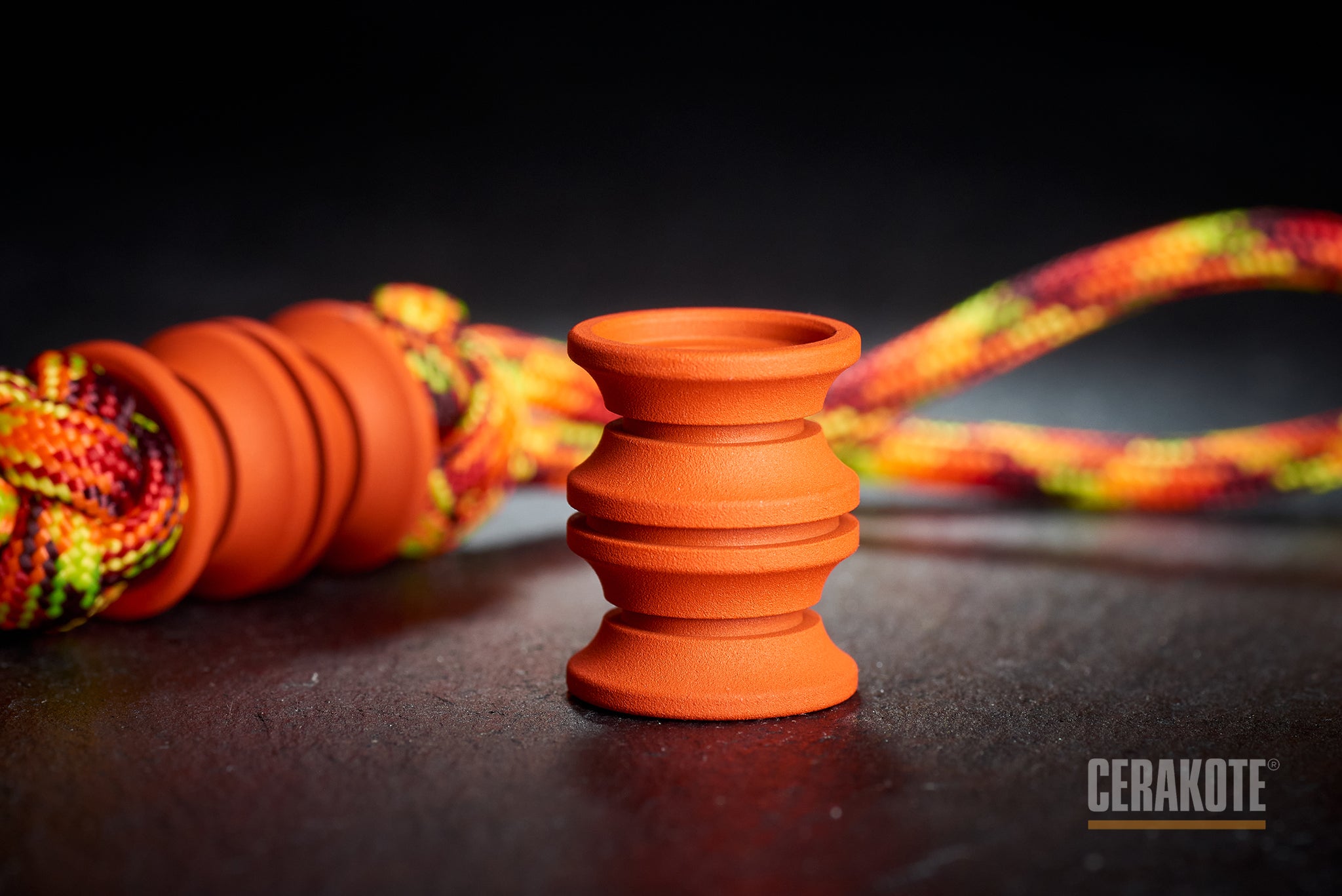 Matte H-128 Orange Cerakote finish on a titanium barrel bead.