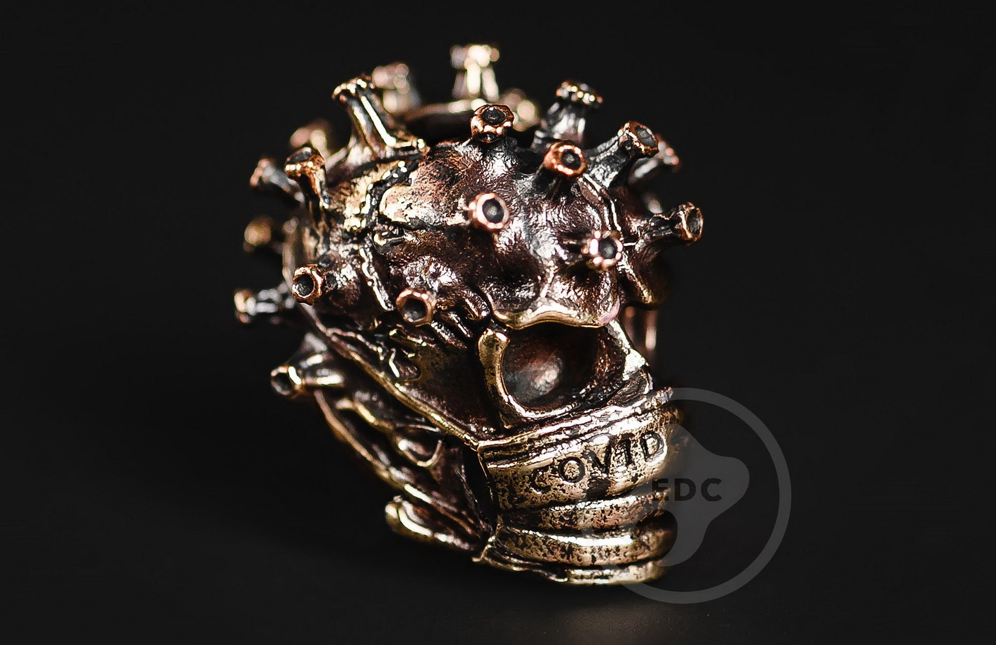 Hand-casted brass lanyard bead depicting a Toxic Biohazard skull with a surgical mask.