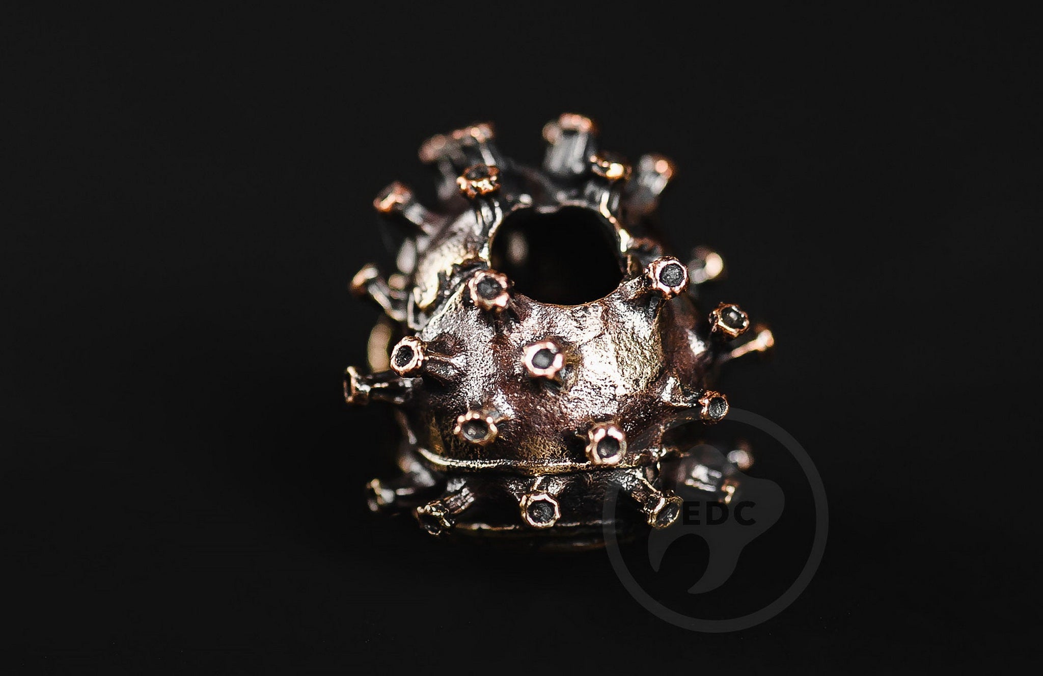 Profile view of the masked biohazard skull bead showing the antique blackened finish.-1