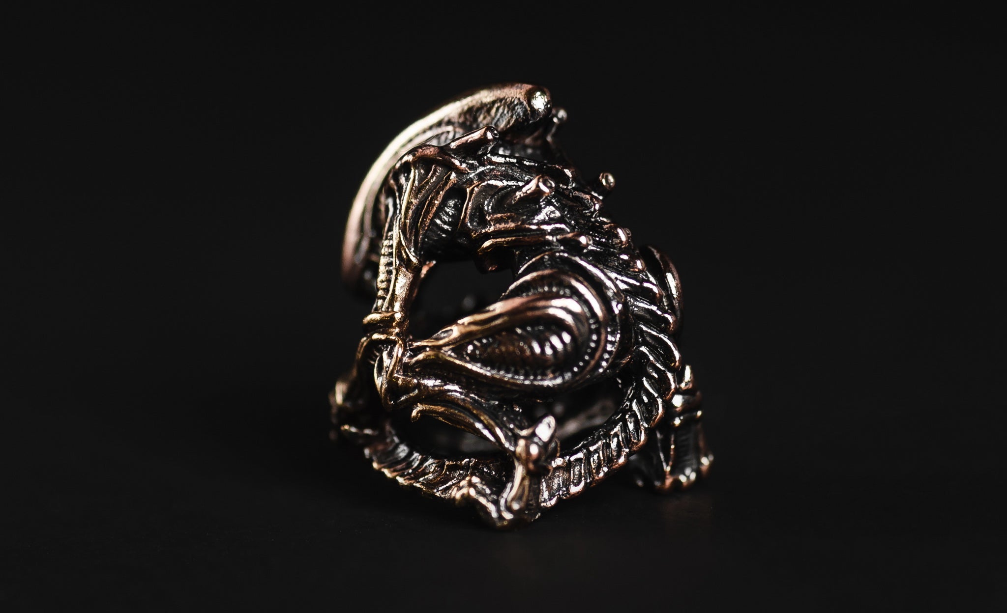 Profile view of the elongated Alien head brass bead showing the antique blackened finish.-1