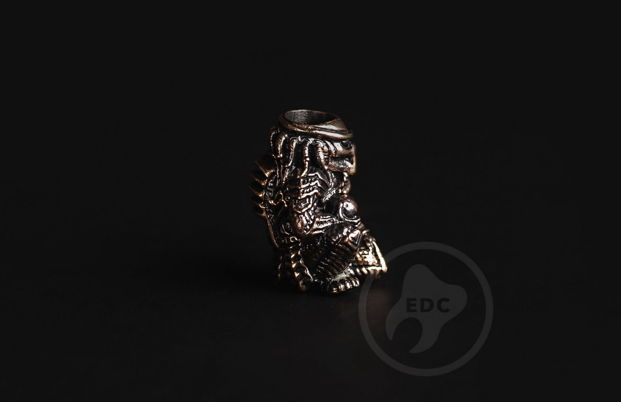 Predator brass bead attached to a tactical knife lanyard with 550 paracord.