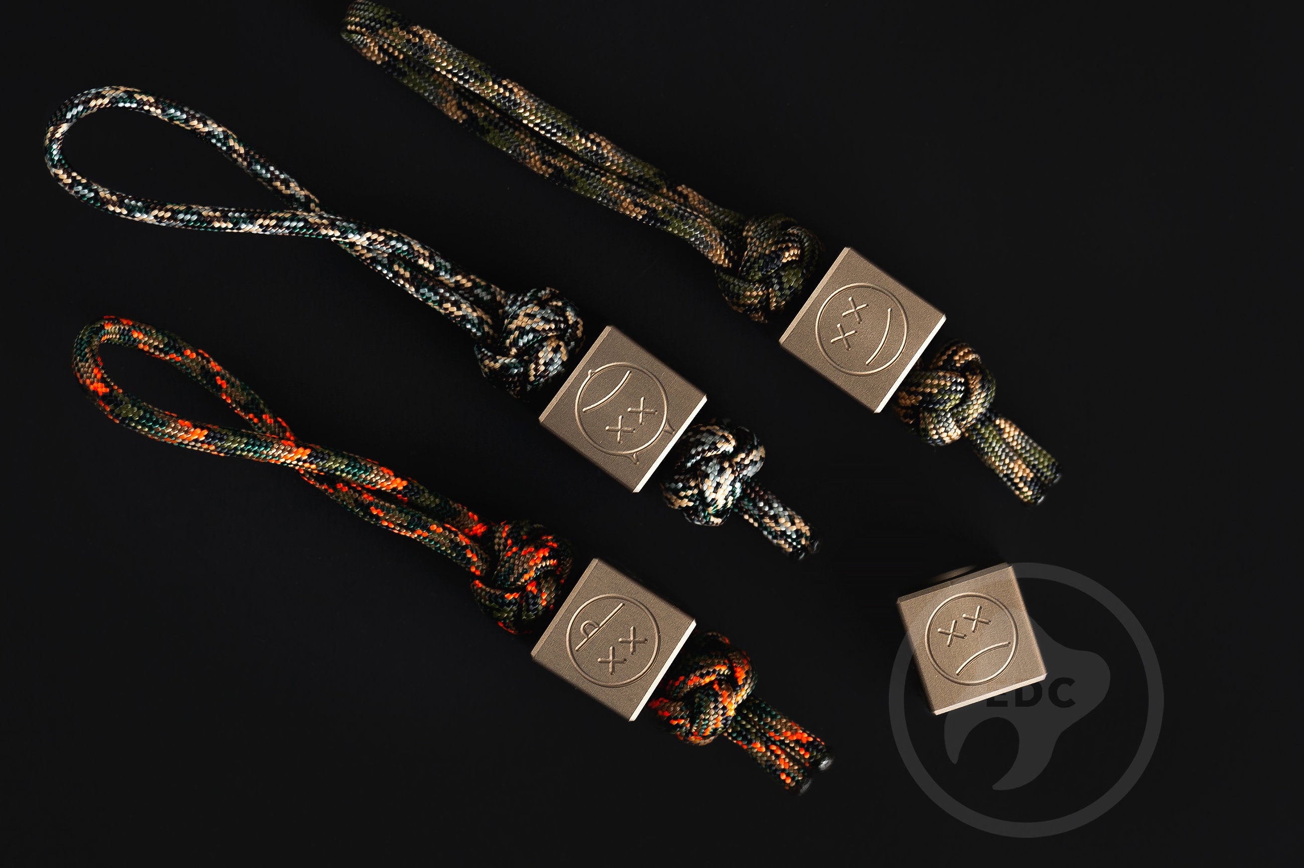 Dark hardcoat aluminum Sad Face bead showing precision machining.-1