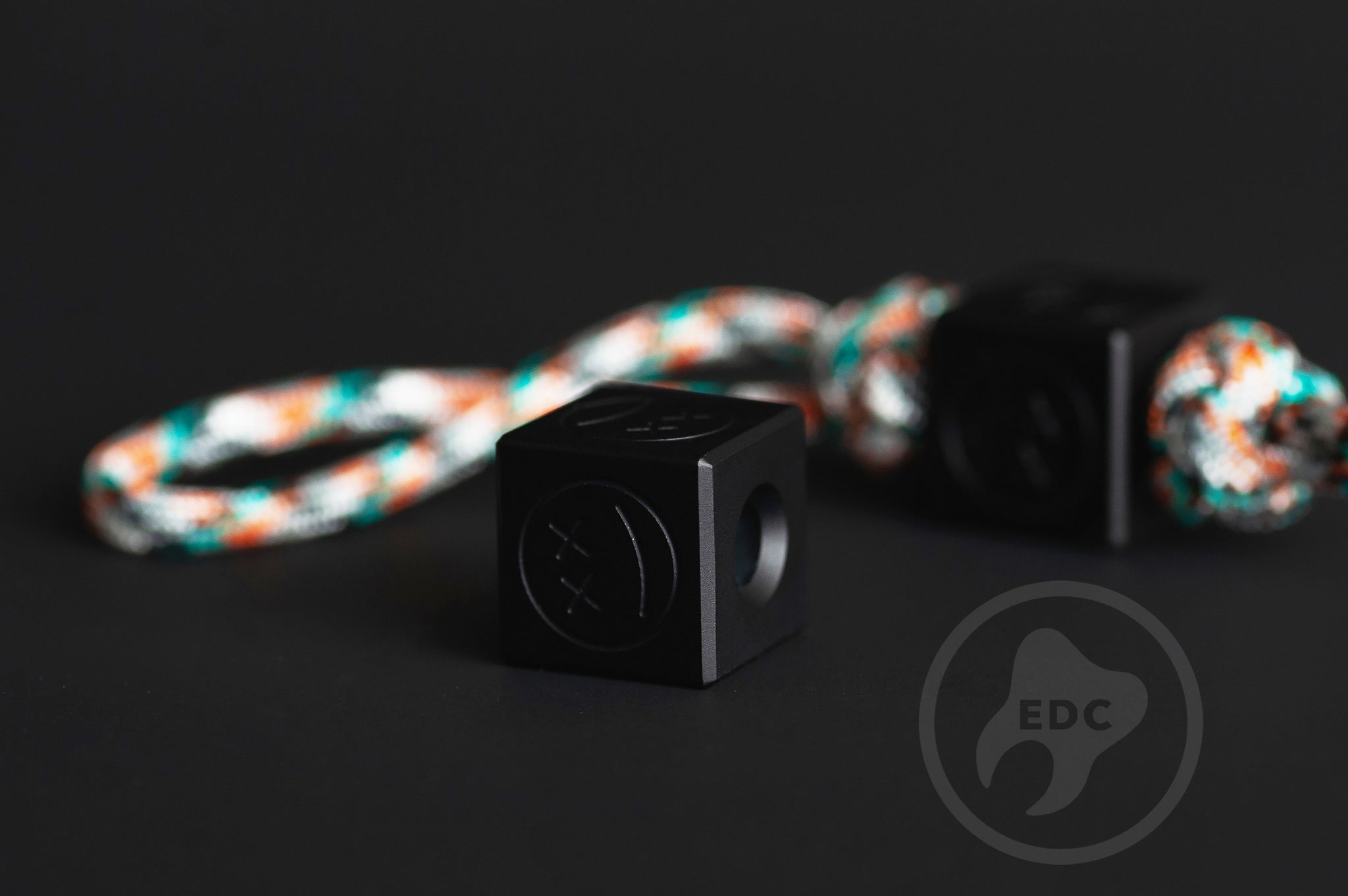 Macro shot of the matte black Type III hard anodized finish on a cube bead.