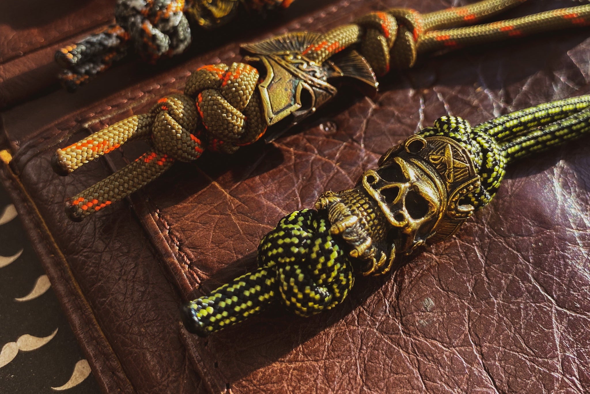 Profile view of the antique-finished brass pirate skull bead showing the 6mm lanyard hole.