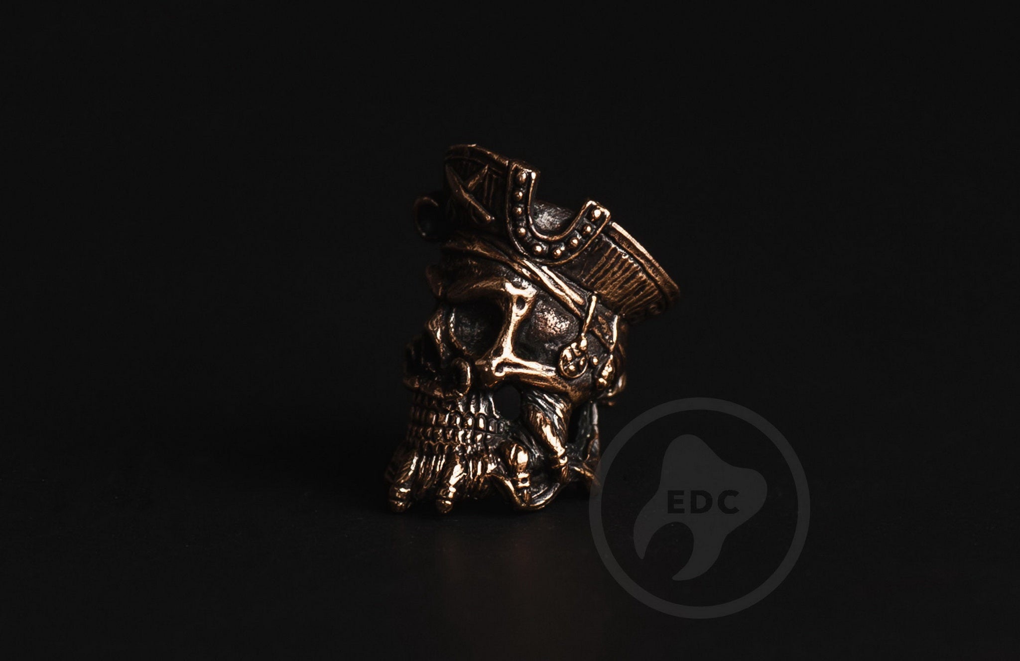 Close-up of the detailed beard and skull features on the brass pirate EDC bead.-1