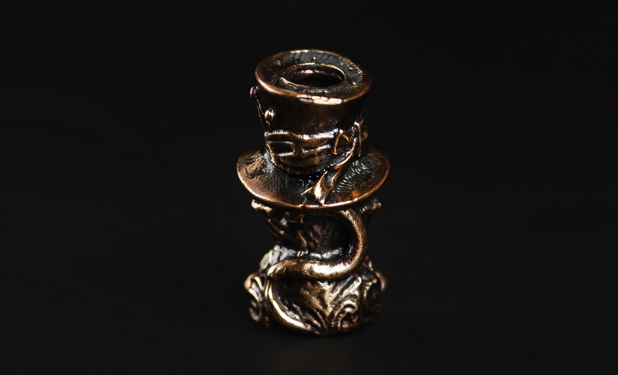 XL Cheshire Cat brass bead acting as a counterweight on a large knife lanyard.