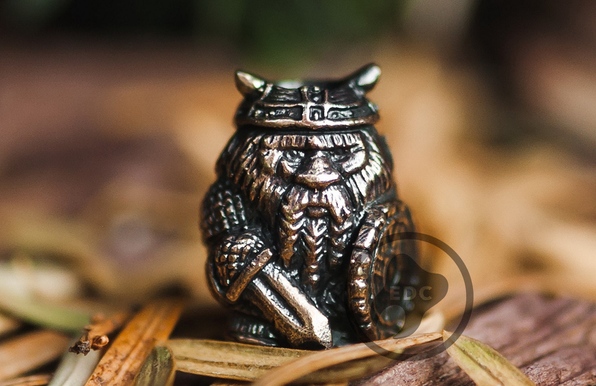 Small brass Viking Berserker terminal bead for paracord lanyard ends.