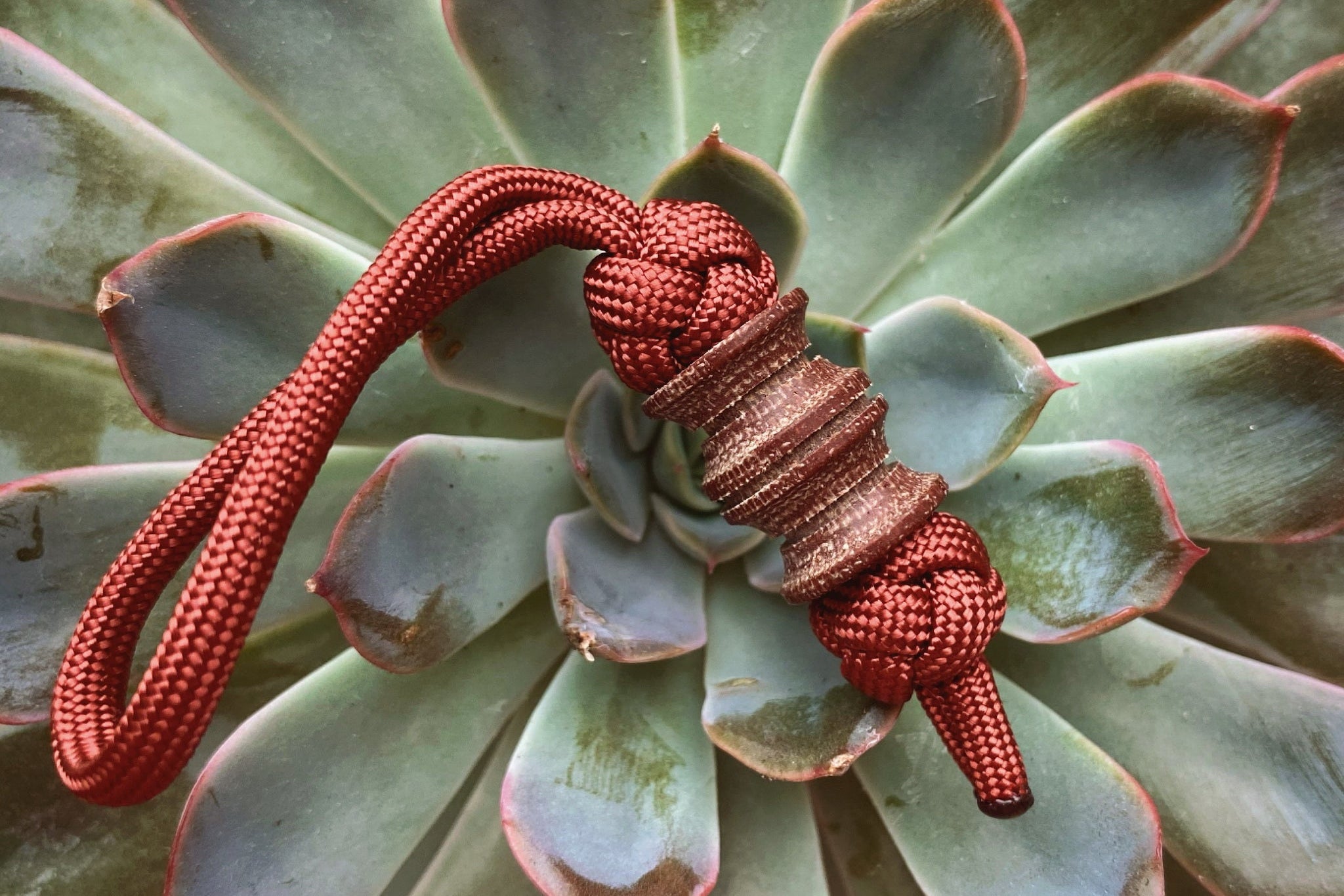 Custom folding knife with a matching Brown Micarta lanyard bead.