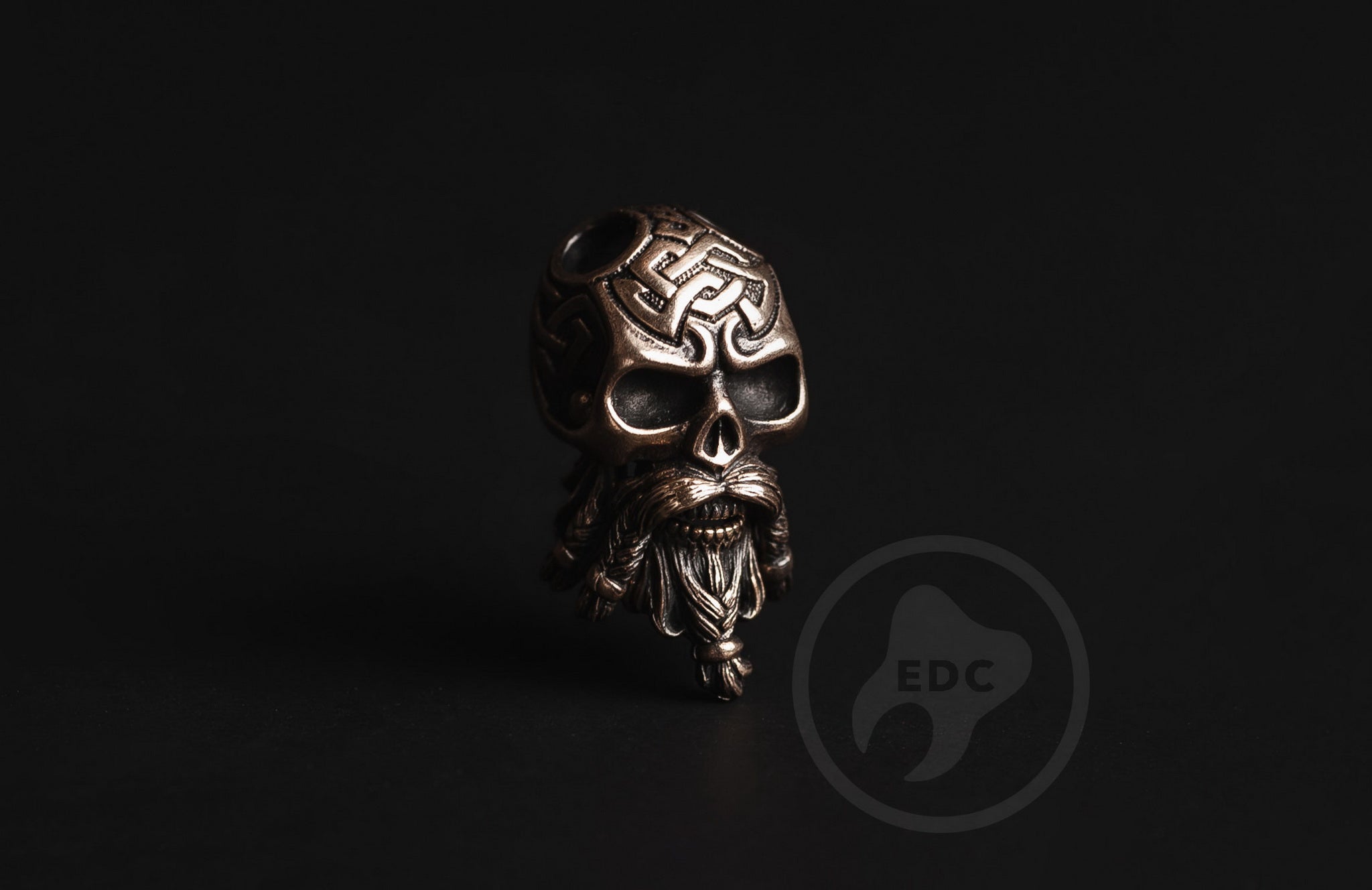 Close-up of the intricate Celtic knot pattern on the brass skull.