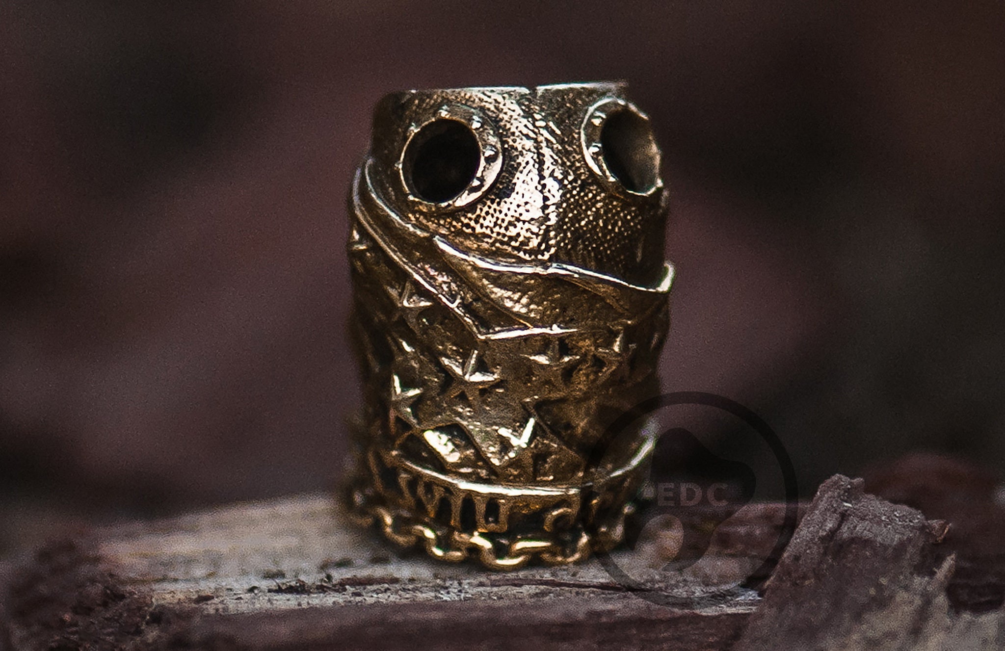 Bottom view showing the large 12mm knot-hider cavity on the brass soldier bead.