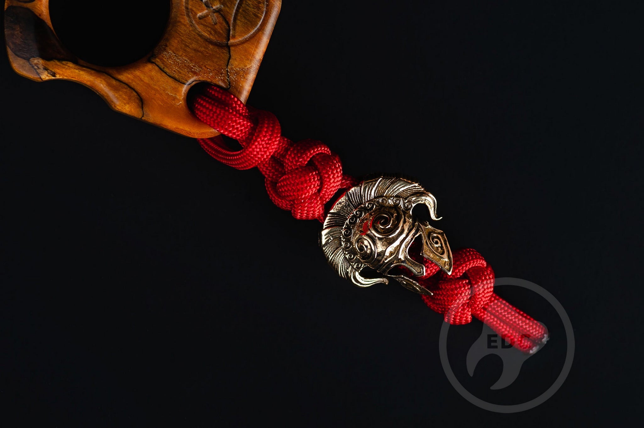 Close up of solid brass Spartan helmet bead on lanyard, Texture detail of curly ash burl pocket sculpture-5