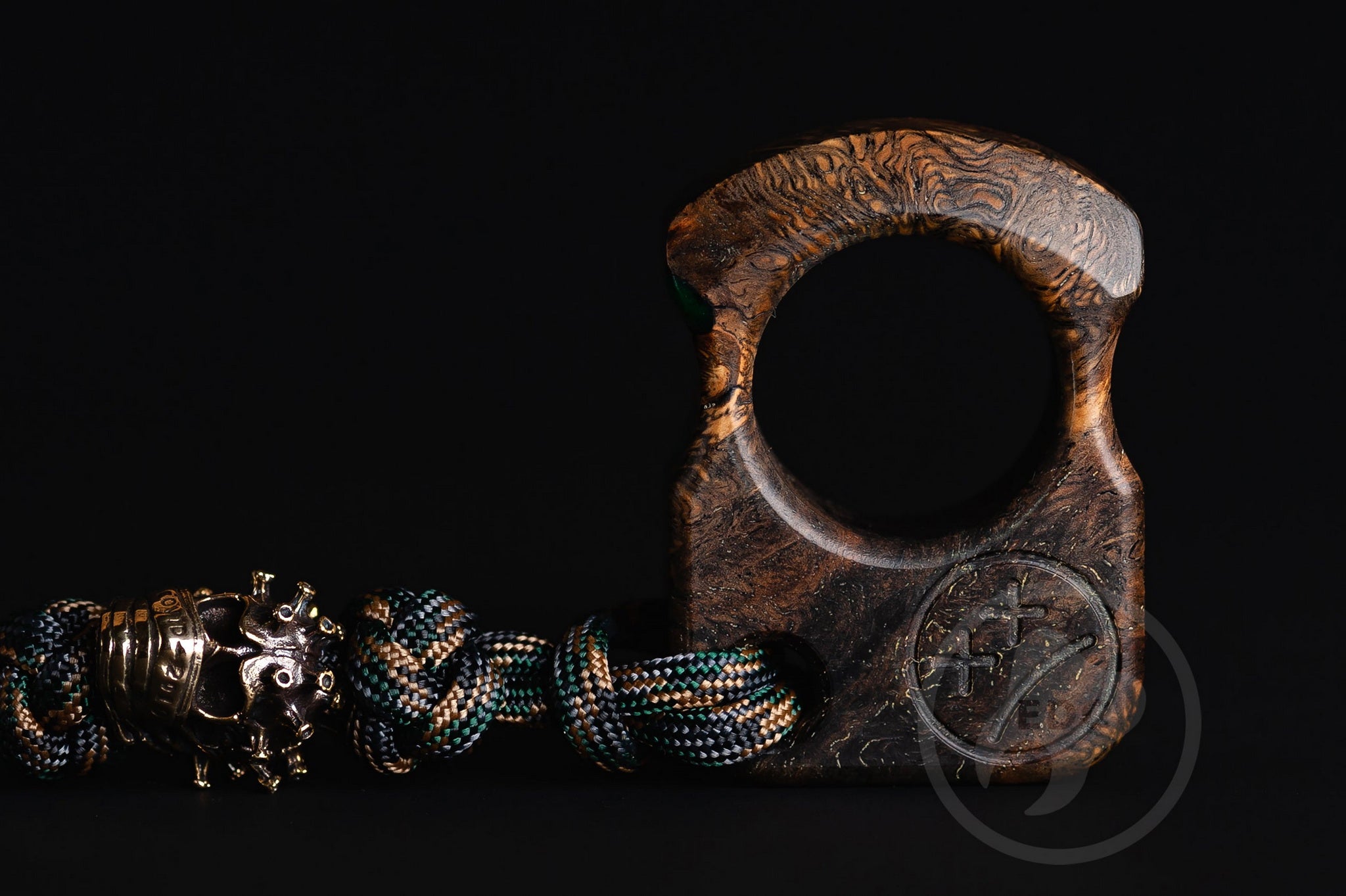 Close up of solid brass Covid-19 bead on green lanyard, Texture detail of oak burl and green resin pocket sculpture
