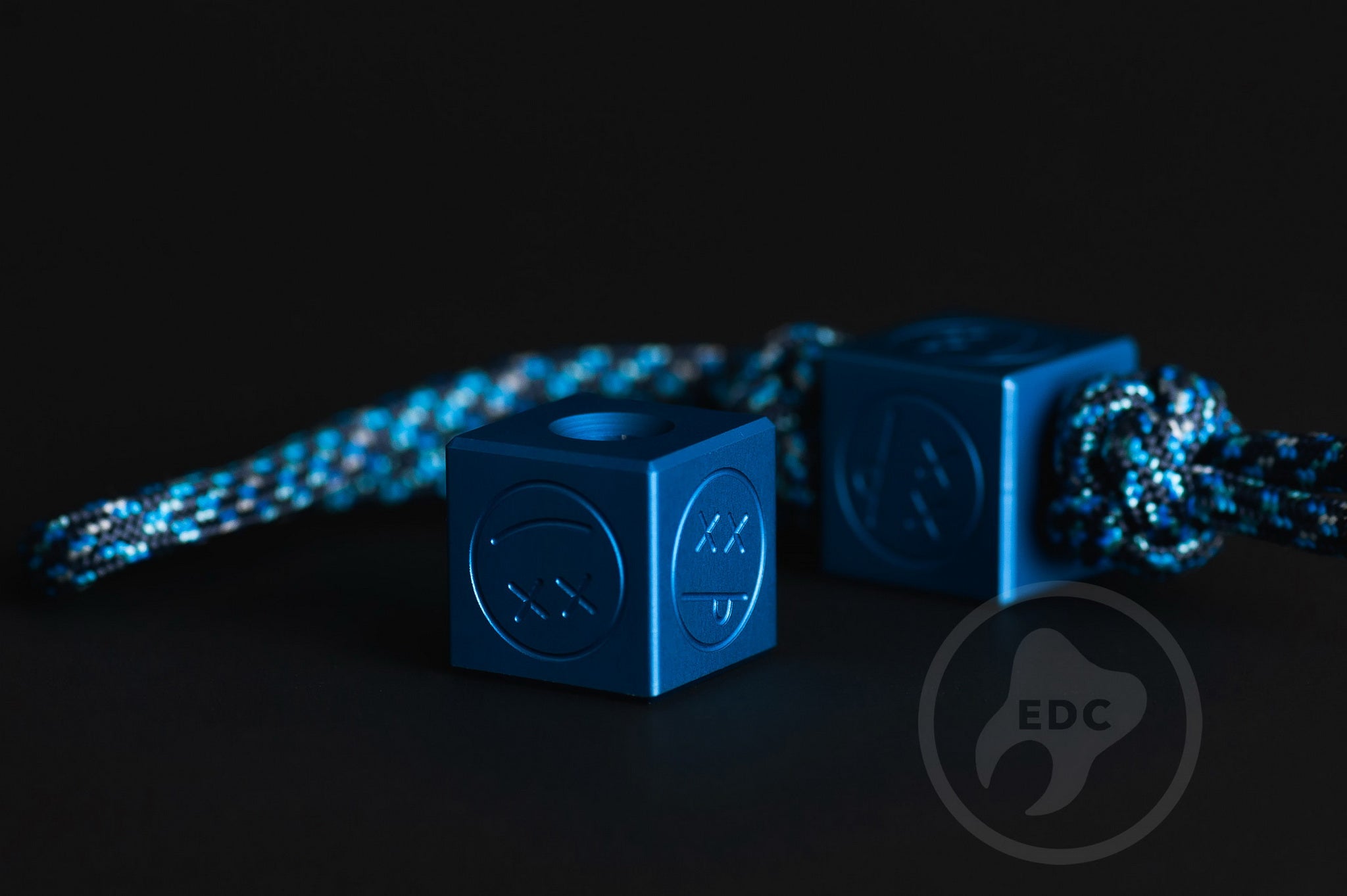 Sandblasted matte blue aluminum Sad Face Cube bead.