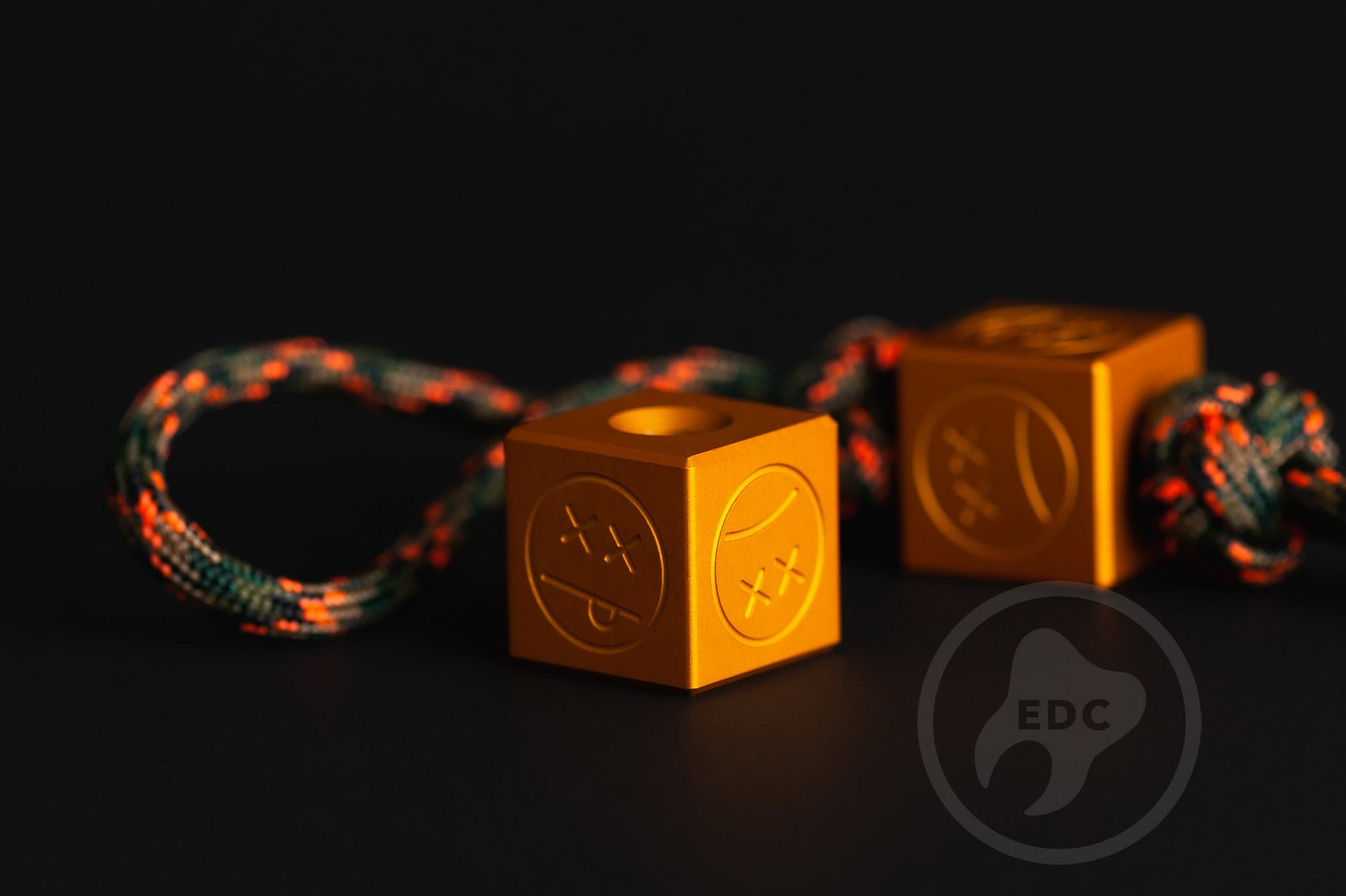 Sandblasted matte orange aluminum Sad Face Cube bead.