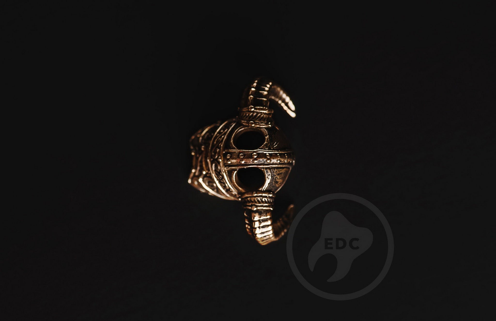 Dual 4mm hole configuration on the Dragon Slayer brass bead for paracord weaving.