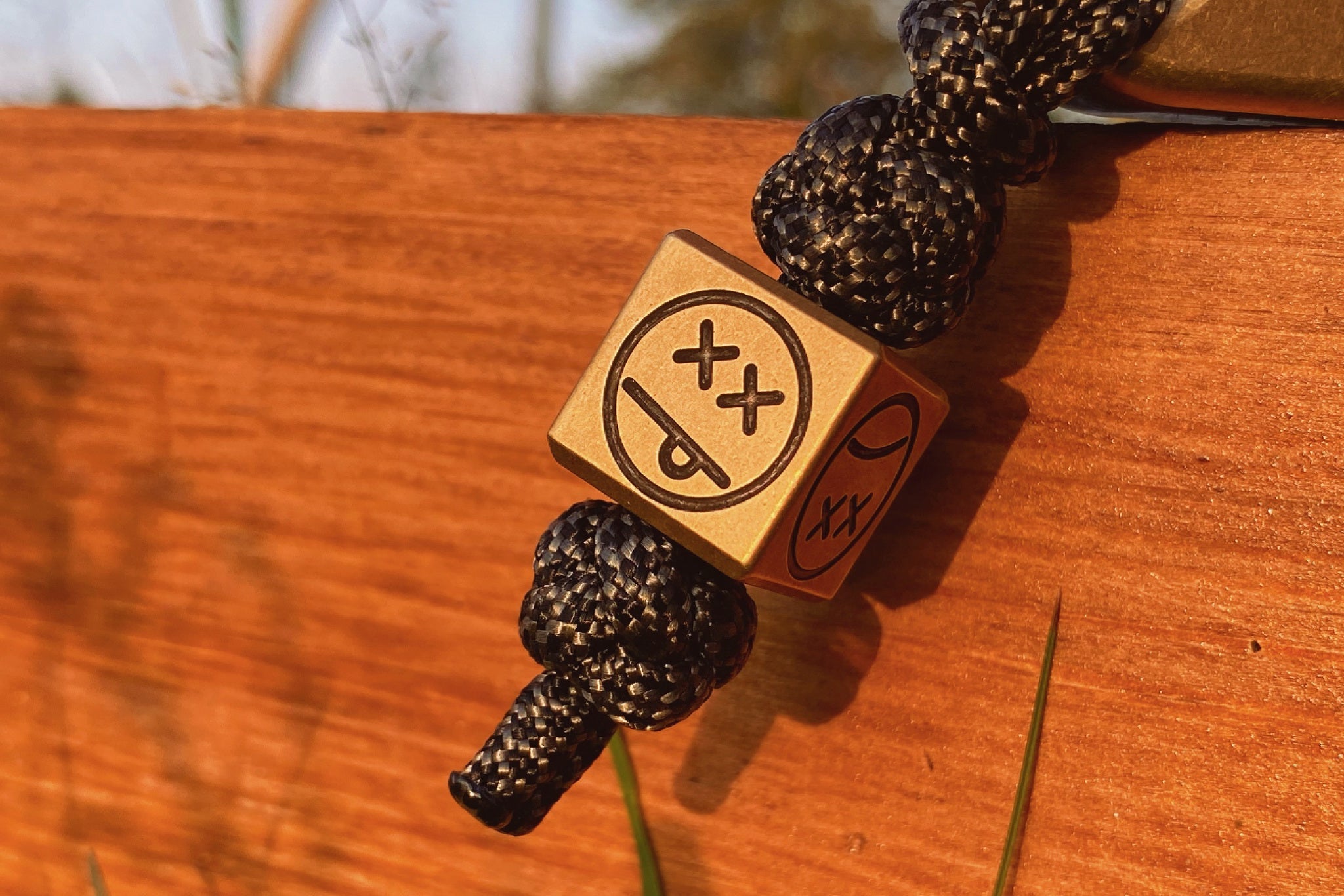 Heavyweight 40g patina brass cube used as a lanyard bead for a pocket knife.-1