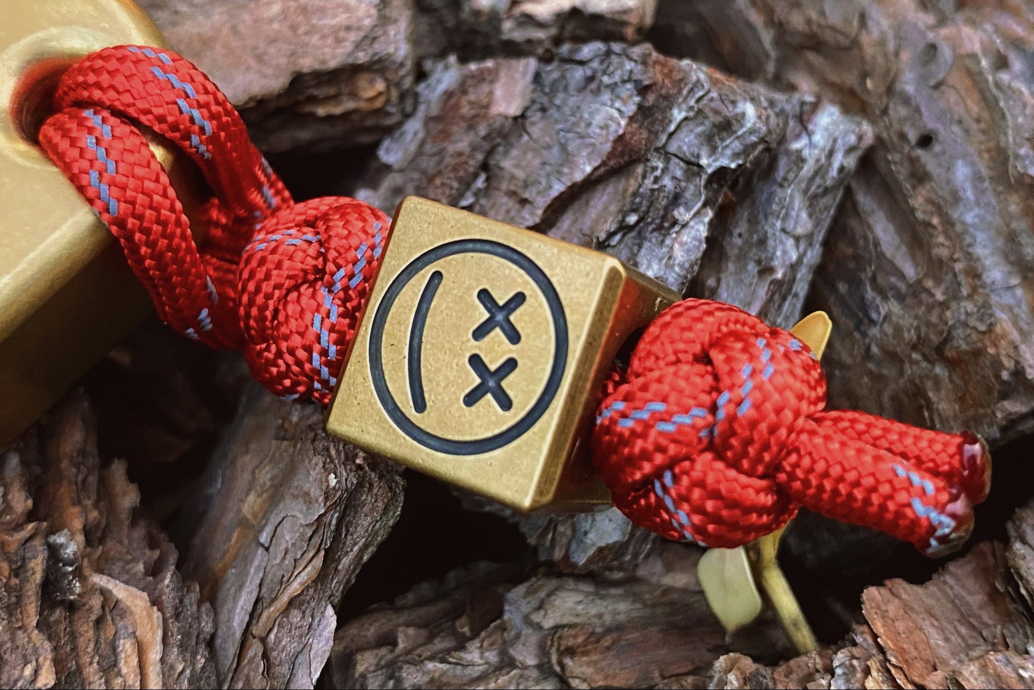 Close-up of the antique patina and engraved sad expression on the brass bead.