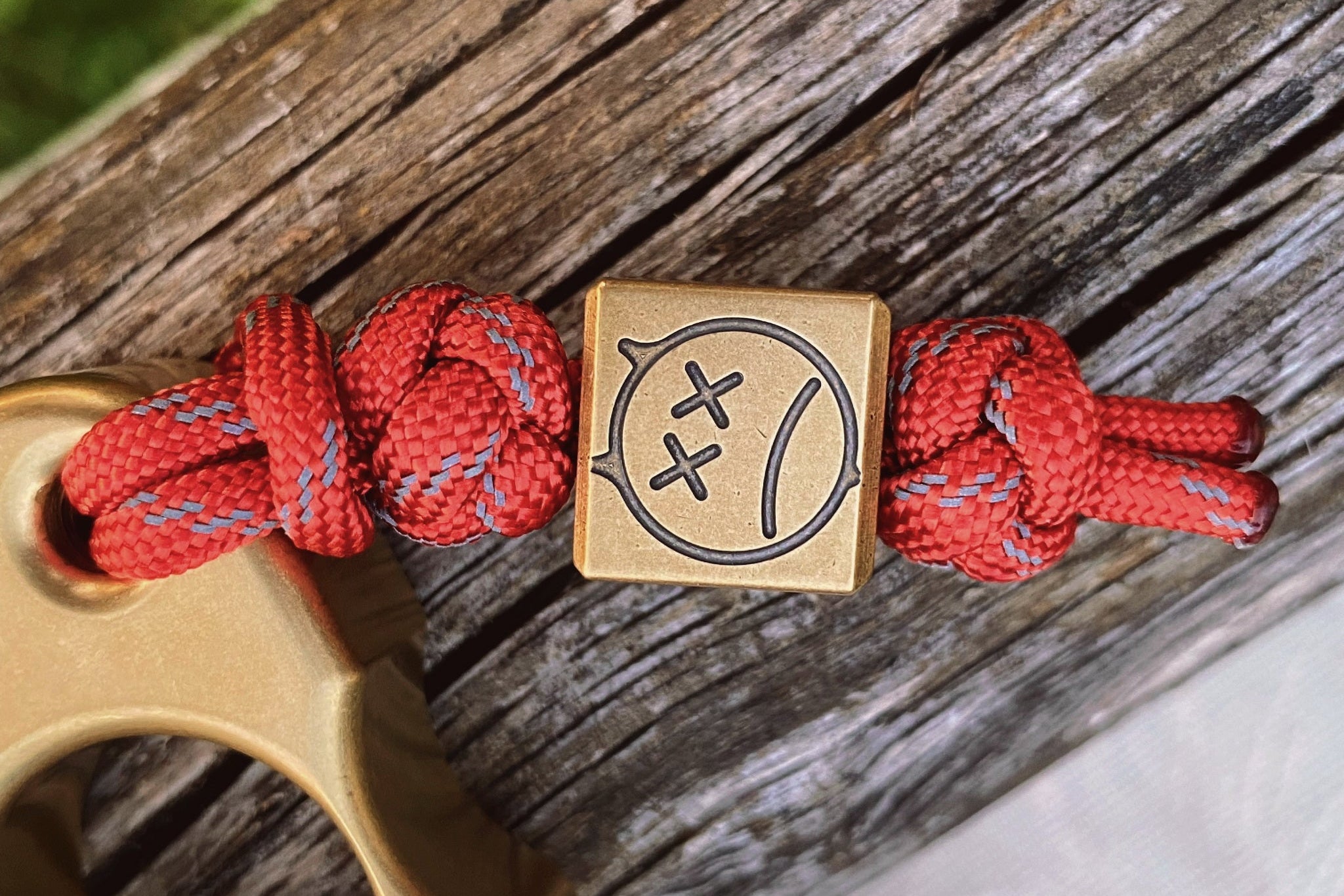 Close-up of the antique patina and engraved sad expression on the brass bead.-1