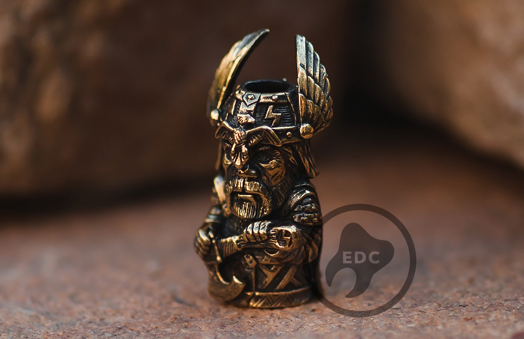 Close-up of the detailed beard and stern face of the Perun brass bead.