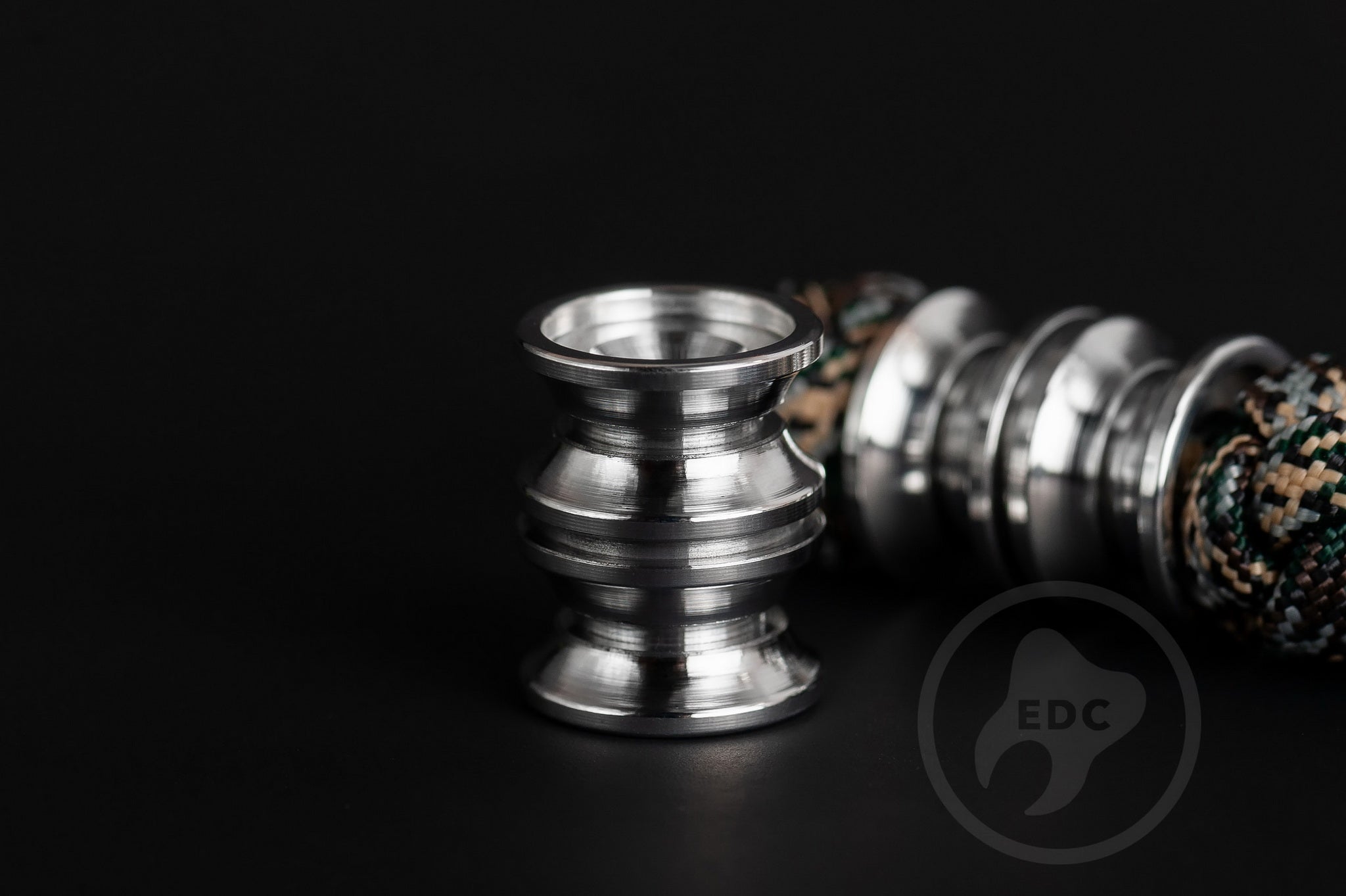 Clean silver-toned metal lanyard bead for custom tools and keychain setups.