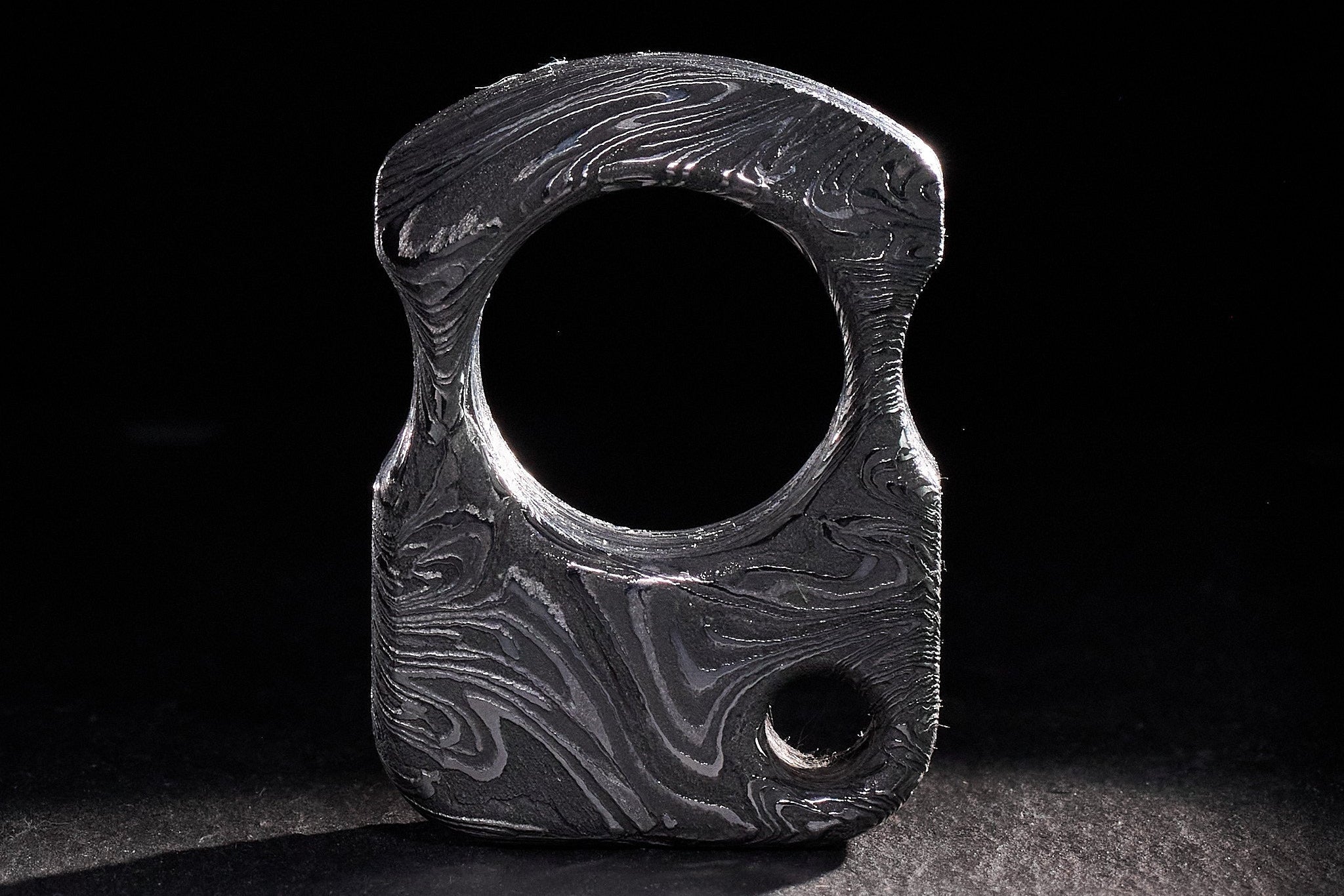 17mm thick heavyweight Damascus steel pocket artifact with CNC-milled lines.