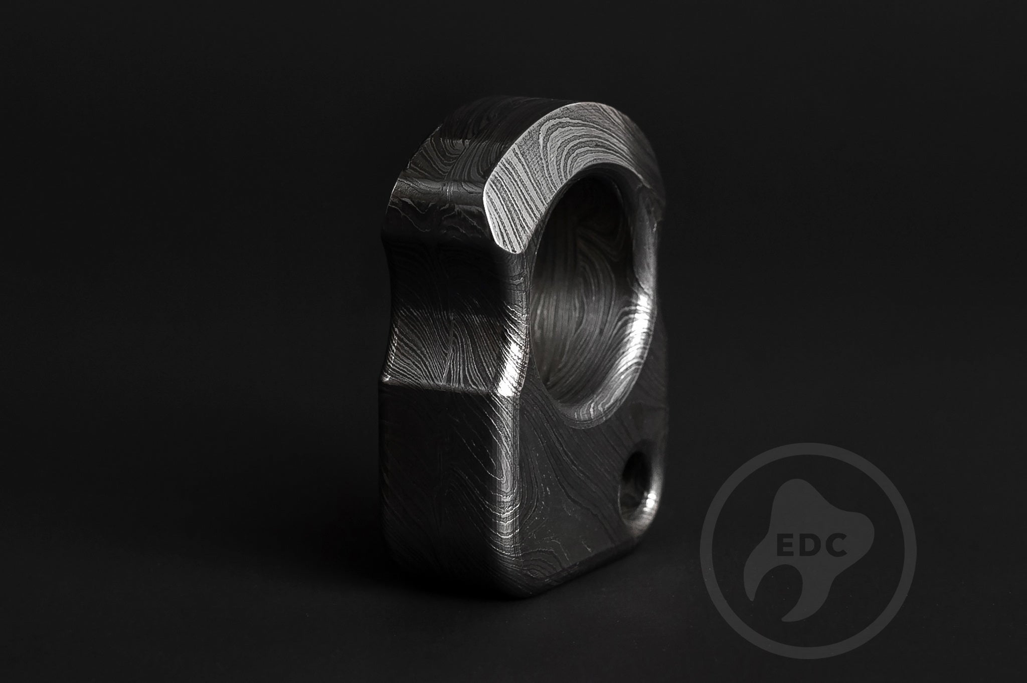 Detailed view of hand-polished and acid-etched Damascus steel texture-1