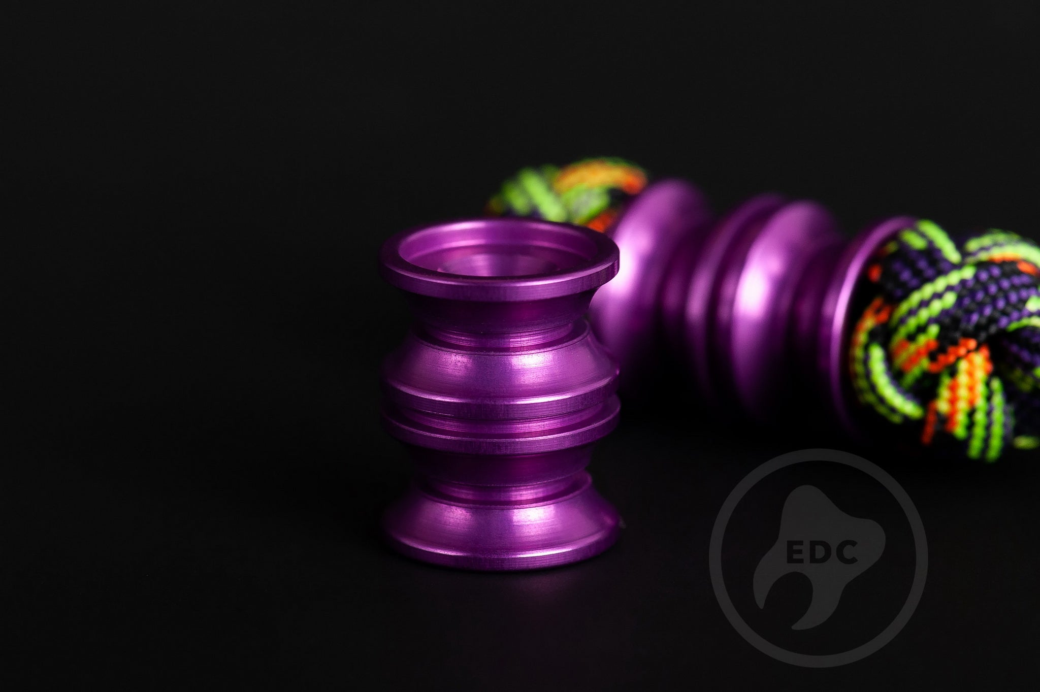 Unique purple metal bead for custom knife and gear setups.
