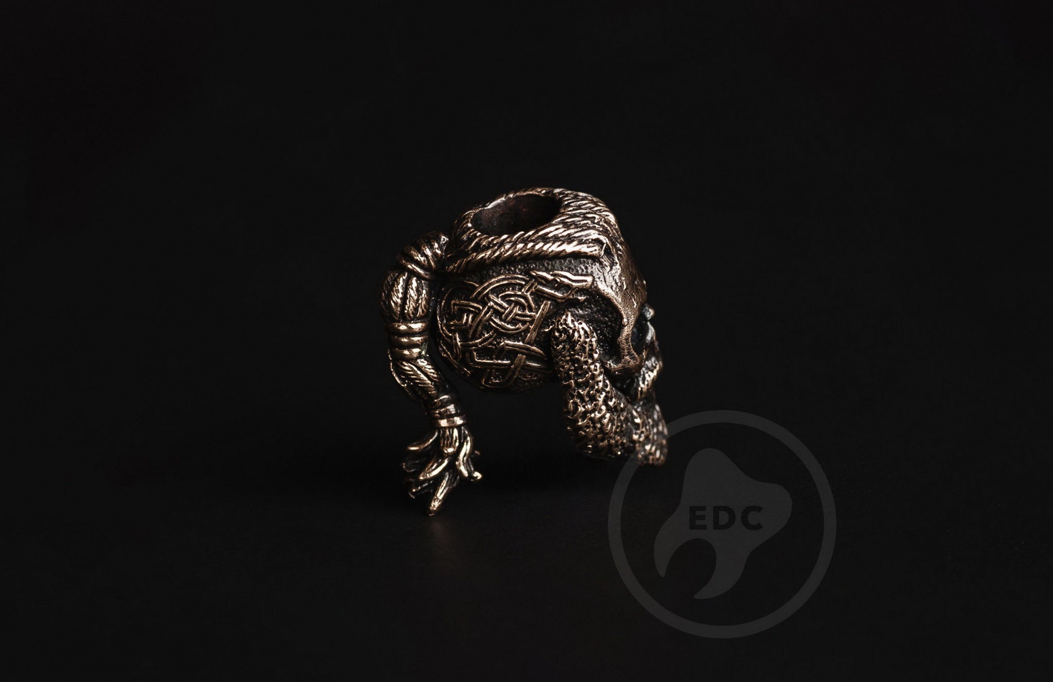 Close-up of the blackened finish and eye sockets on the brass Nordic warrior bead.