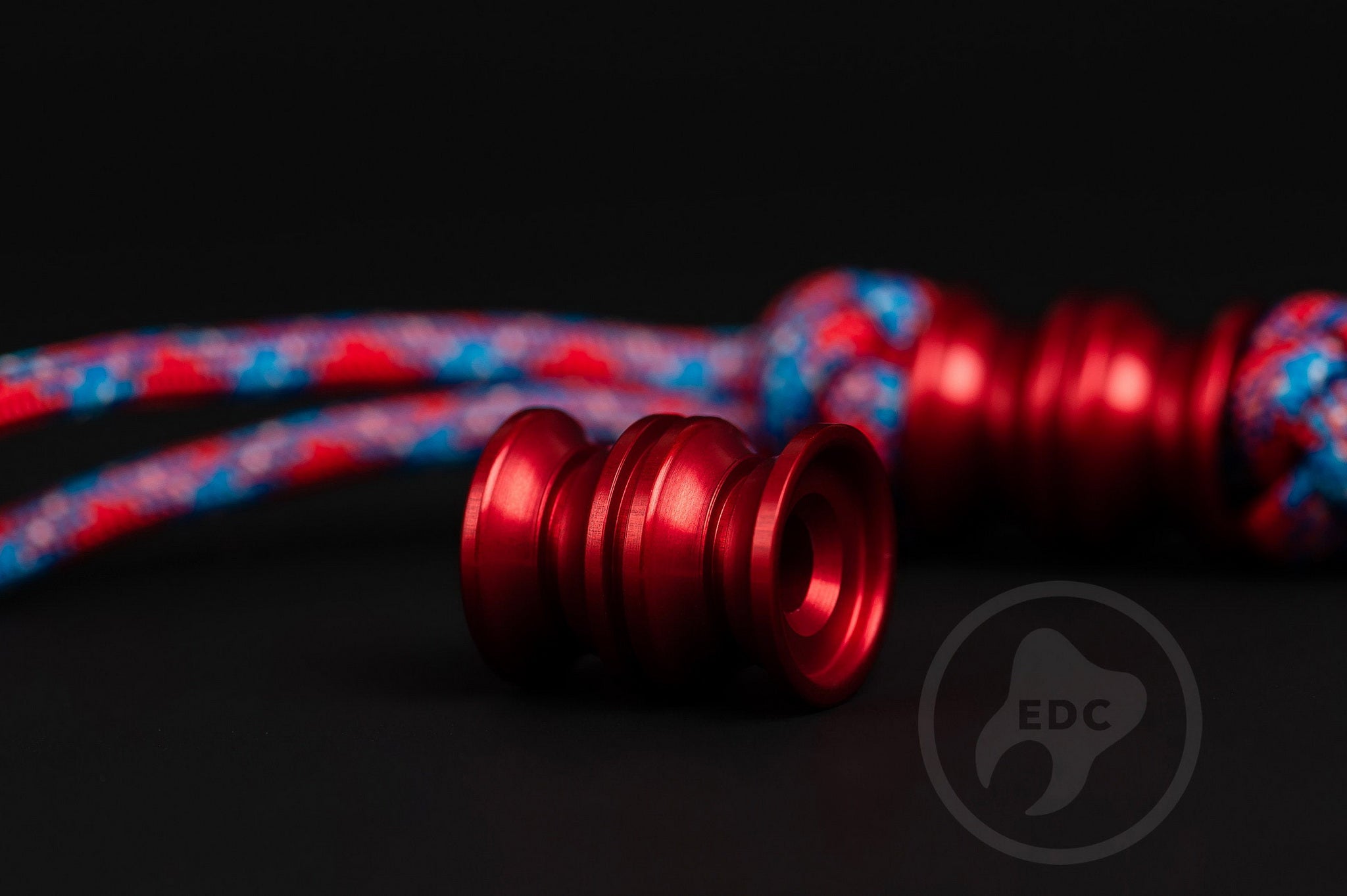 Red anodized aluminum Grooved Barrel paracord bead.