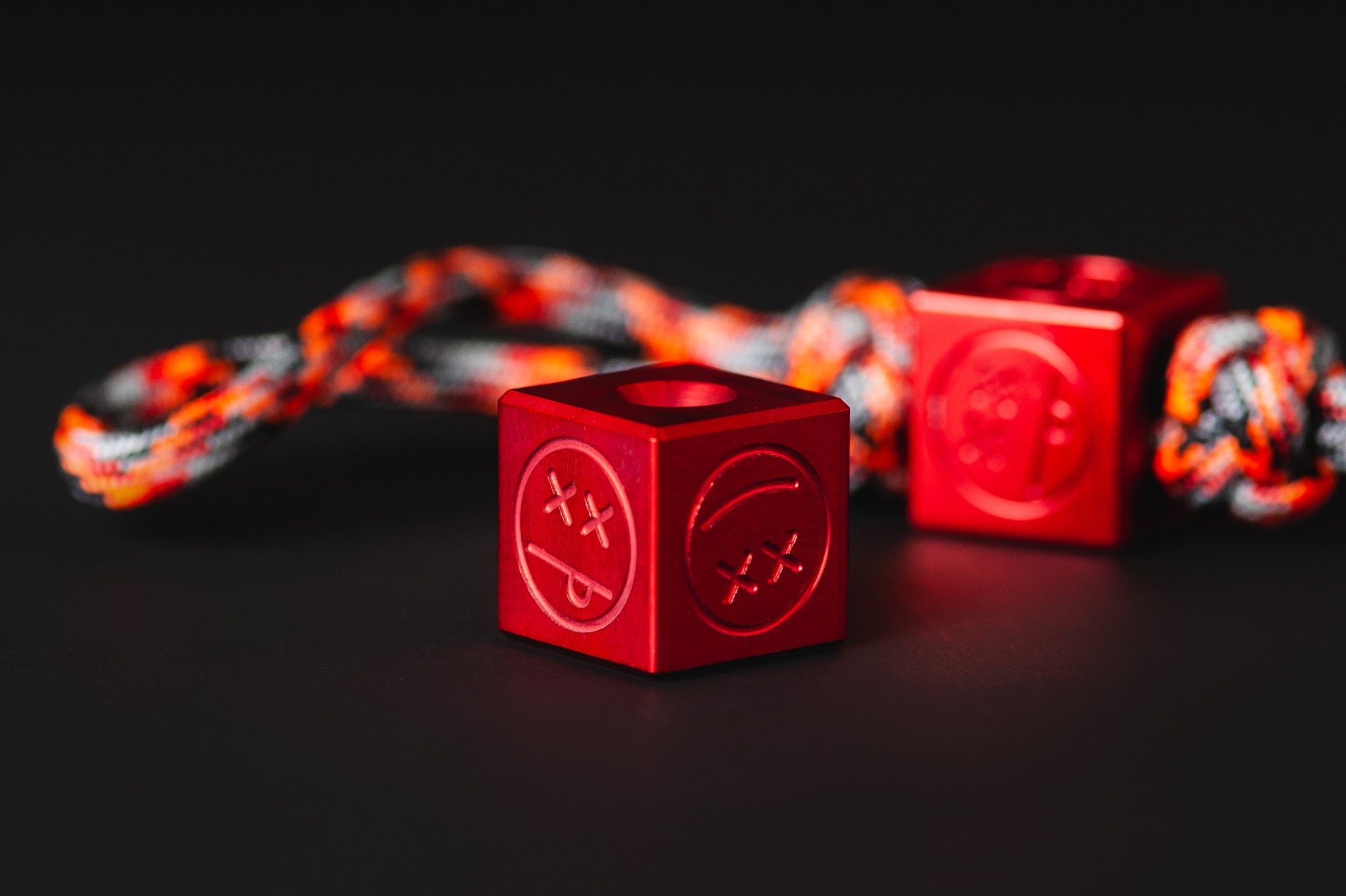 Bright red Type II anodized aluminum Sad Face Cube bead.