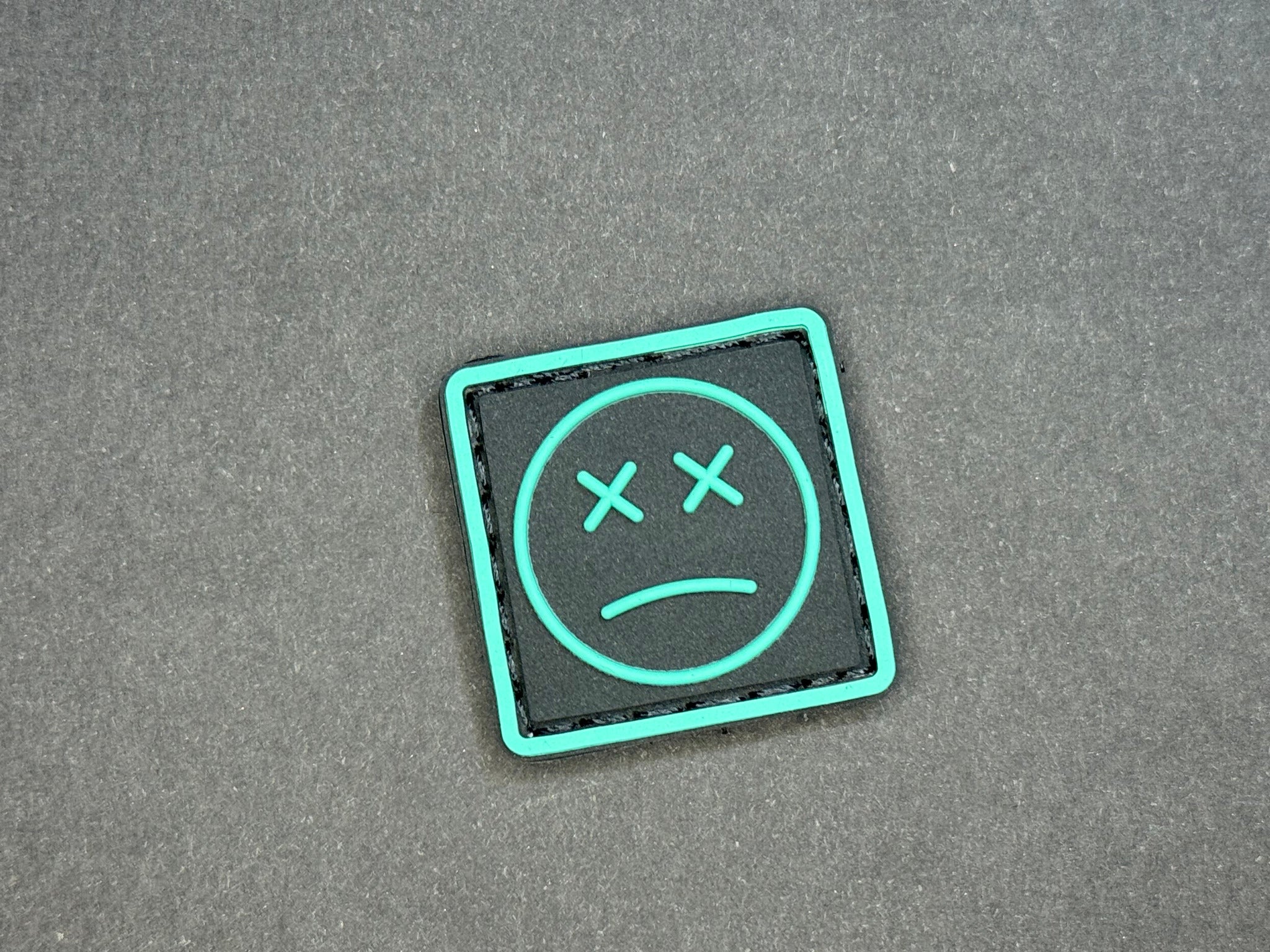 Sad Face Ranger Eye PVC Patch Black and Teal for EDC gear