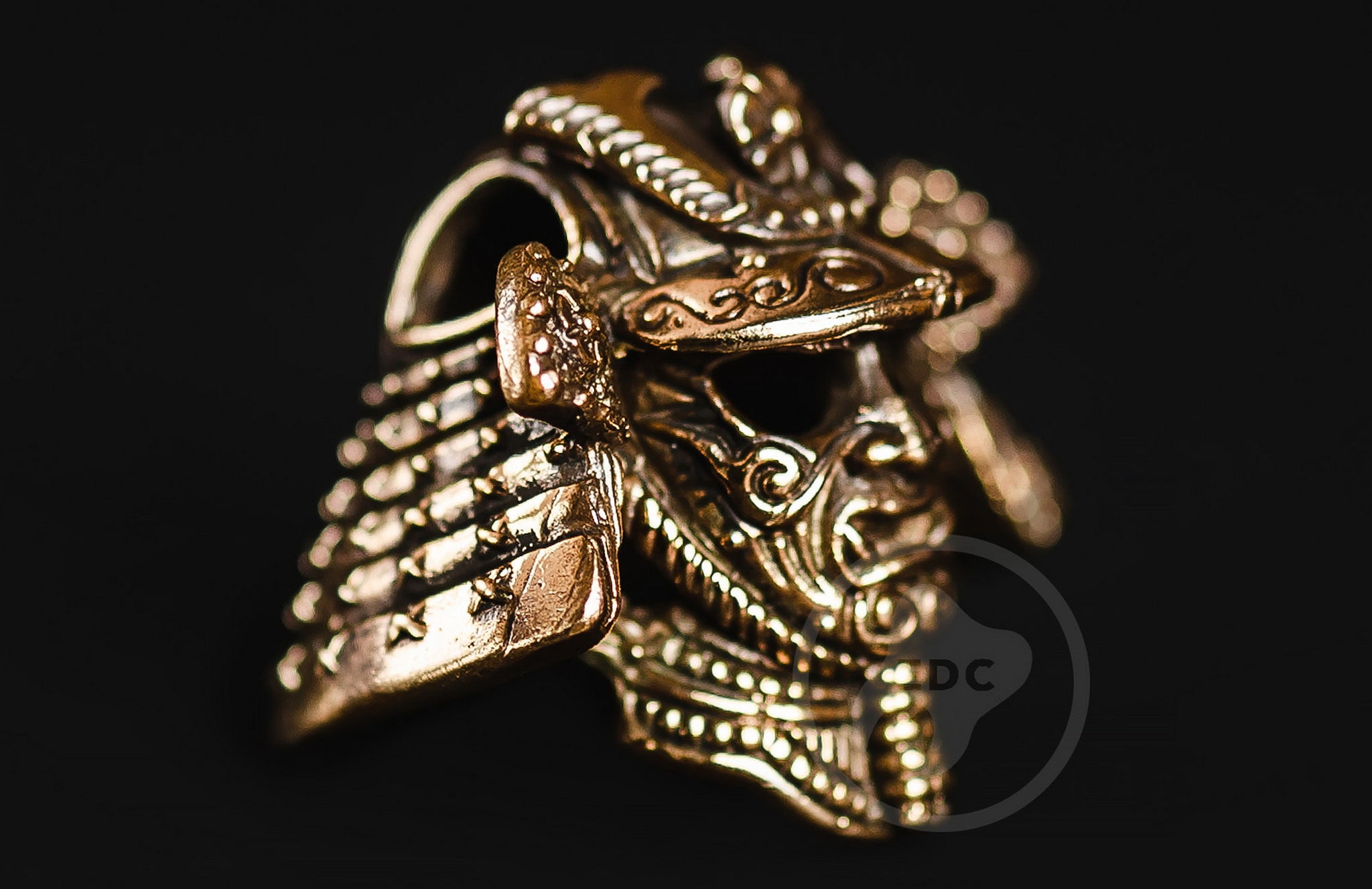 Close-up of the Menpo mask and Shikoro neck guard on the brass Samurai EDC bead.